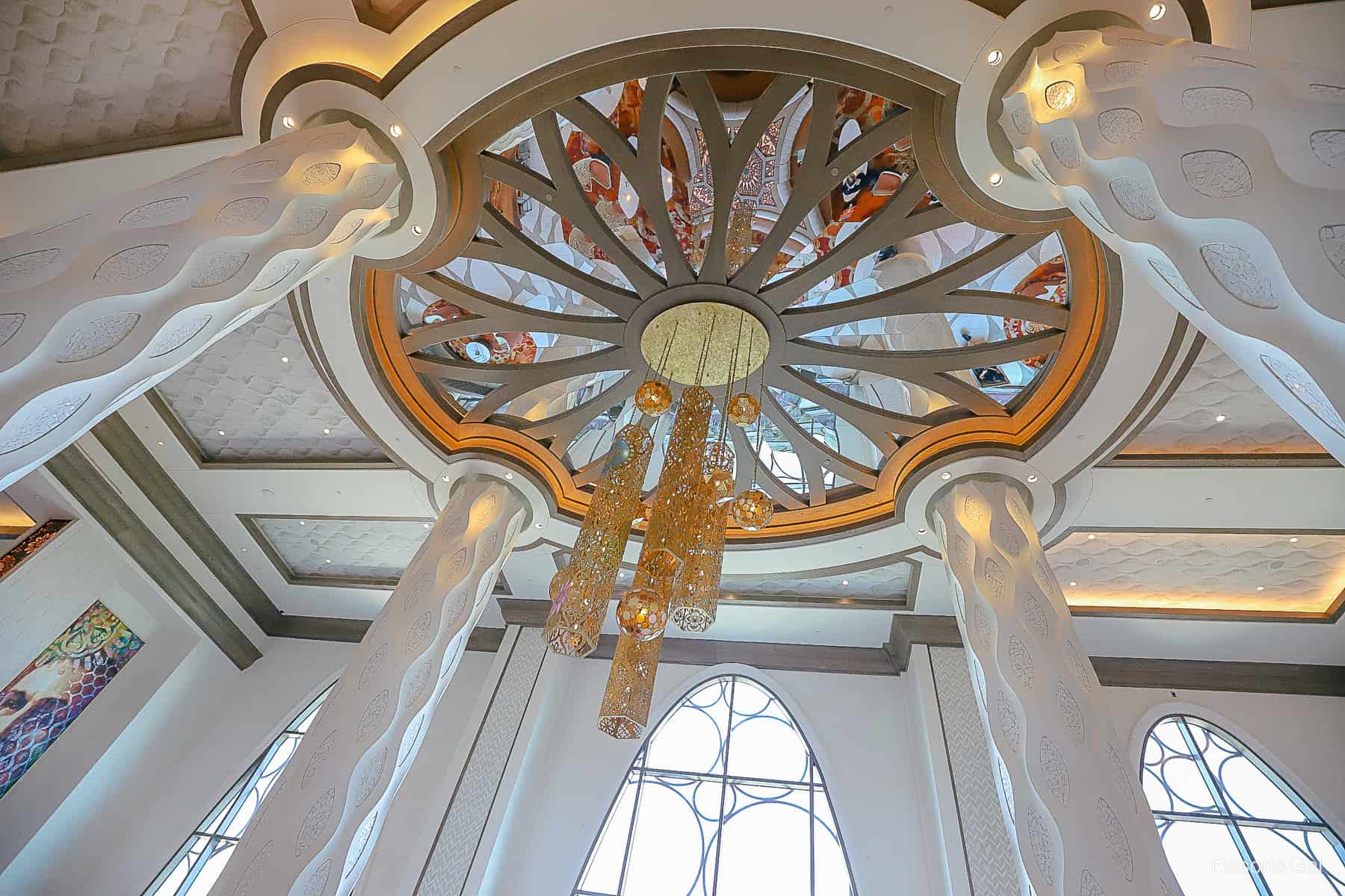 a ceiling fixture in the lobby with mirrors 