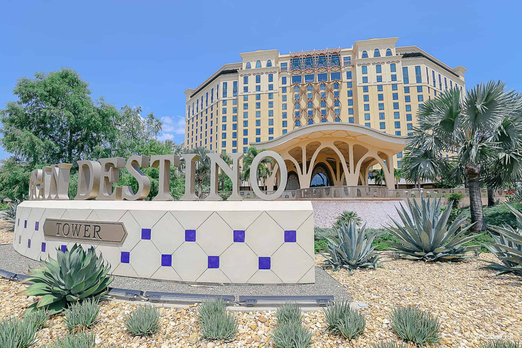 the entrance to Gran Destino Tower with a water feature behind the sign 