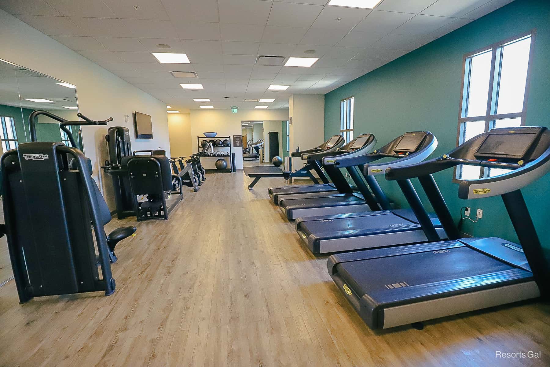 the interior of the gym with treadmills and other fitness equipment 