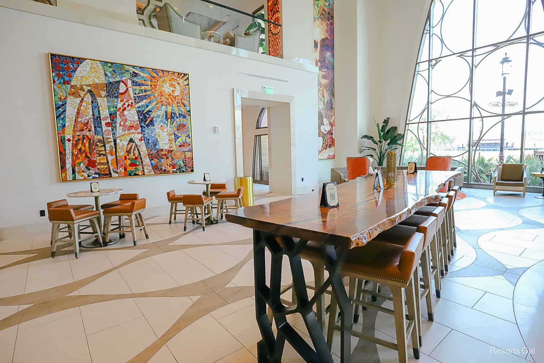 a long table with a wood grain top and leather counter height bar seats 