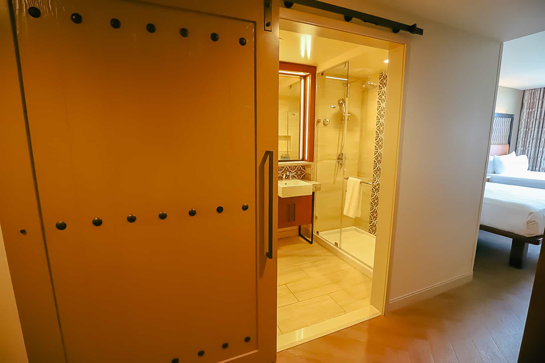 a large sliding door that allows guests to close off the bathroom area from the rest of the room 