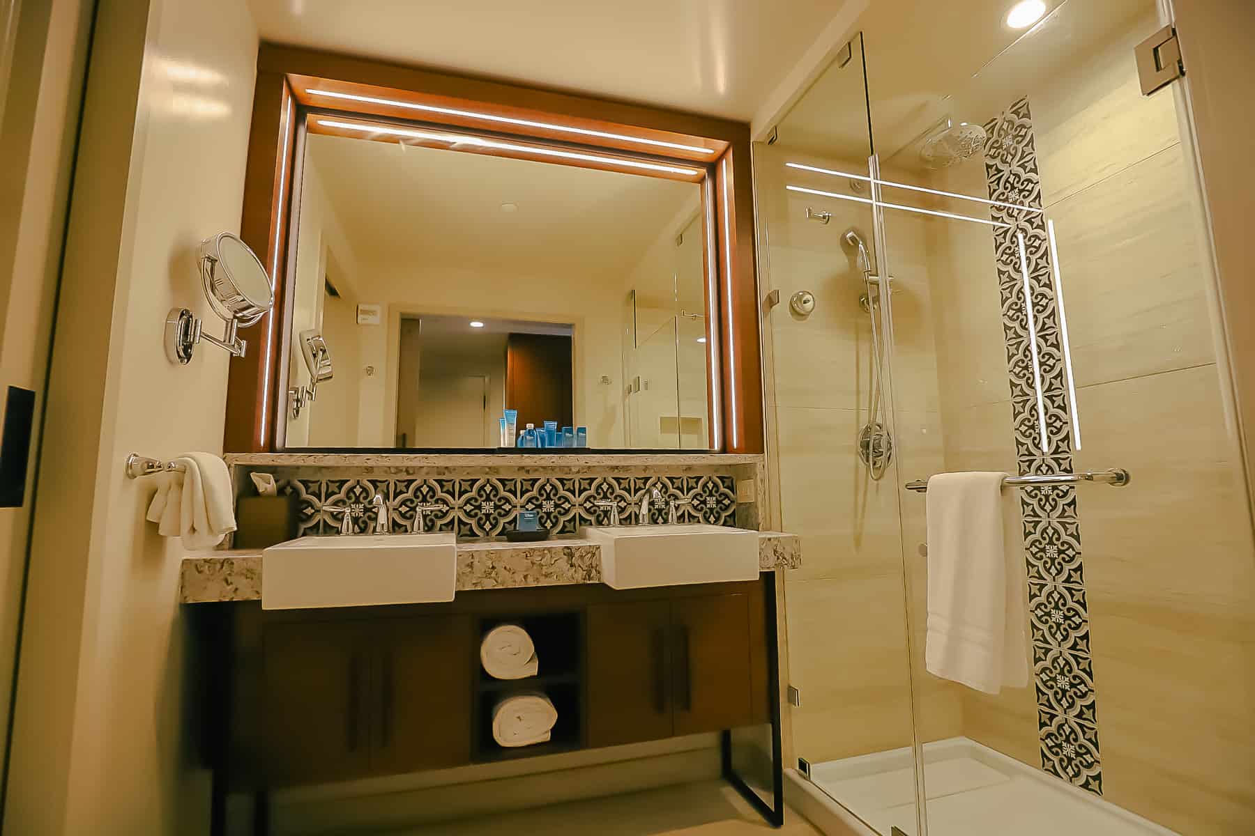 an overall view of the guest bath in a standard room with vanity and shower area 