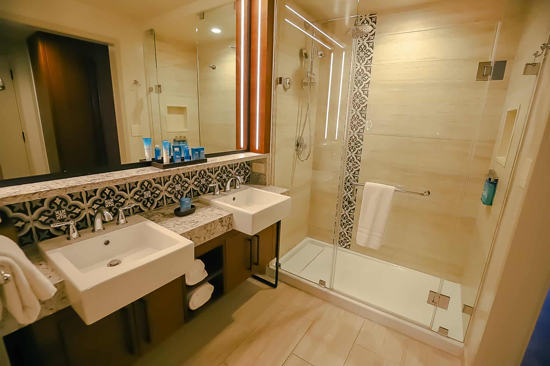 a walk-in shower with glass doors in a standard room at Gran Destino Tower 
