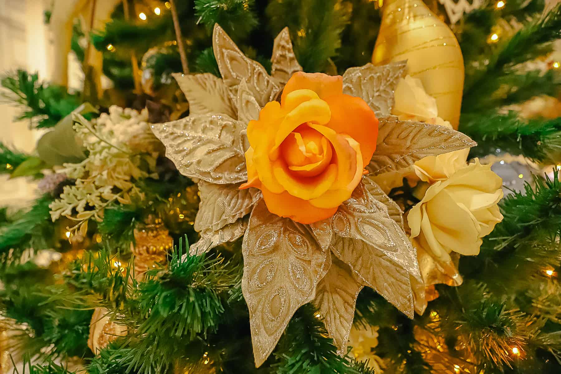 A peach rose placed in the Christmas tree. 