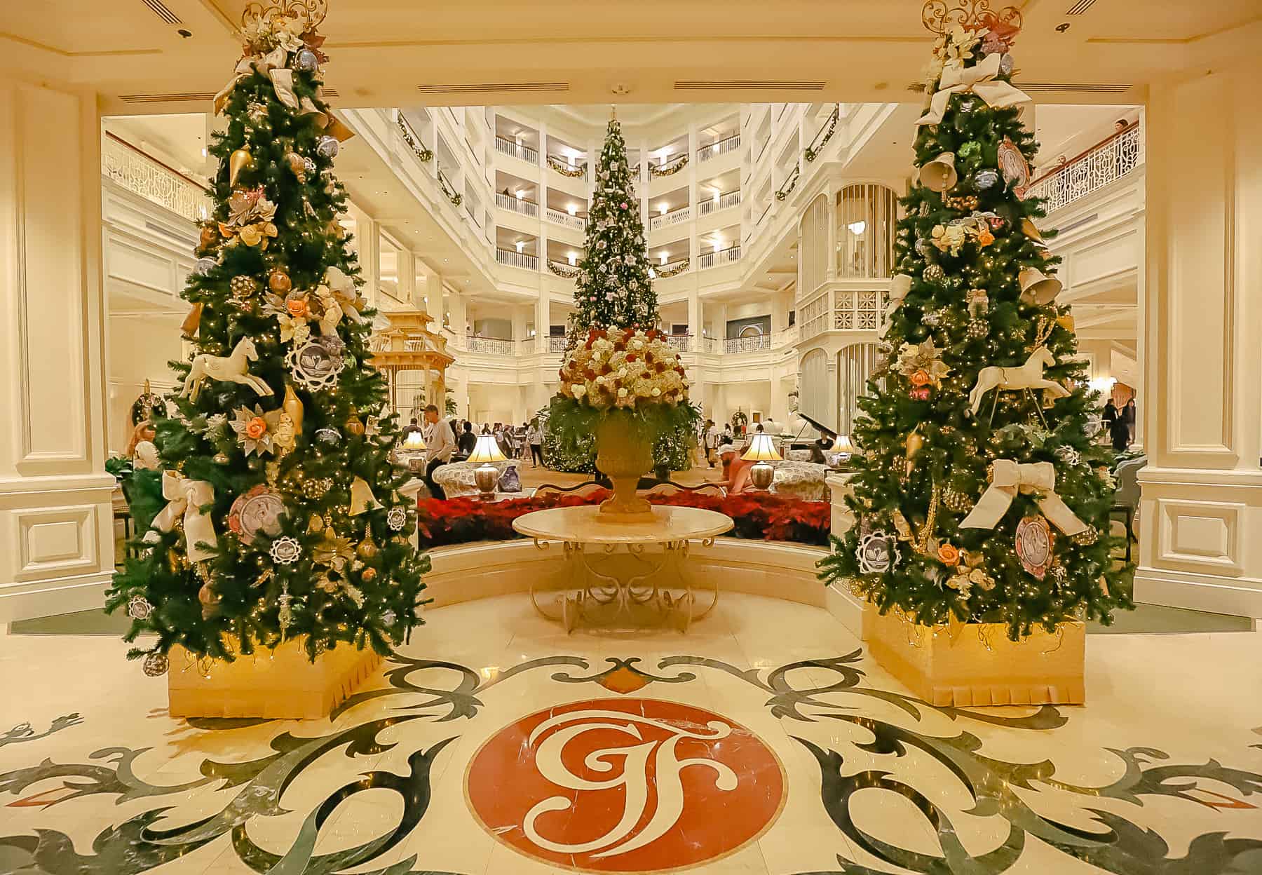 A view of the entrance of Disney's Grand Floridian with Christmas Trees. 
