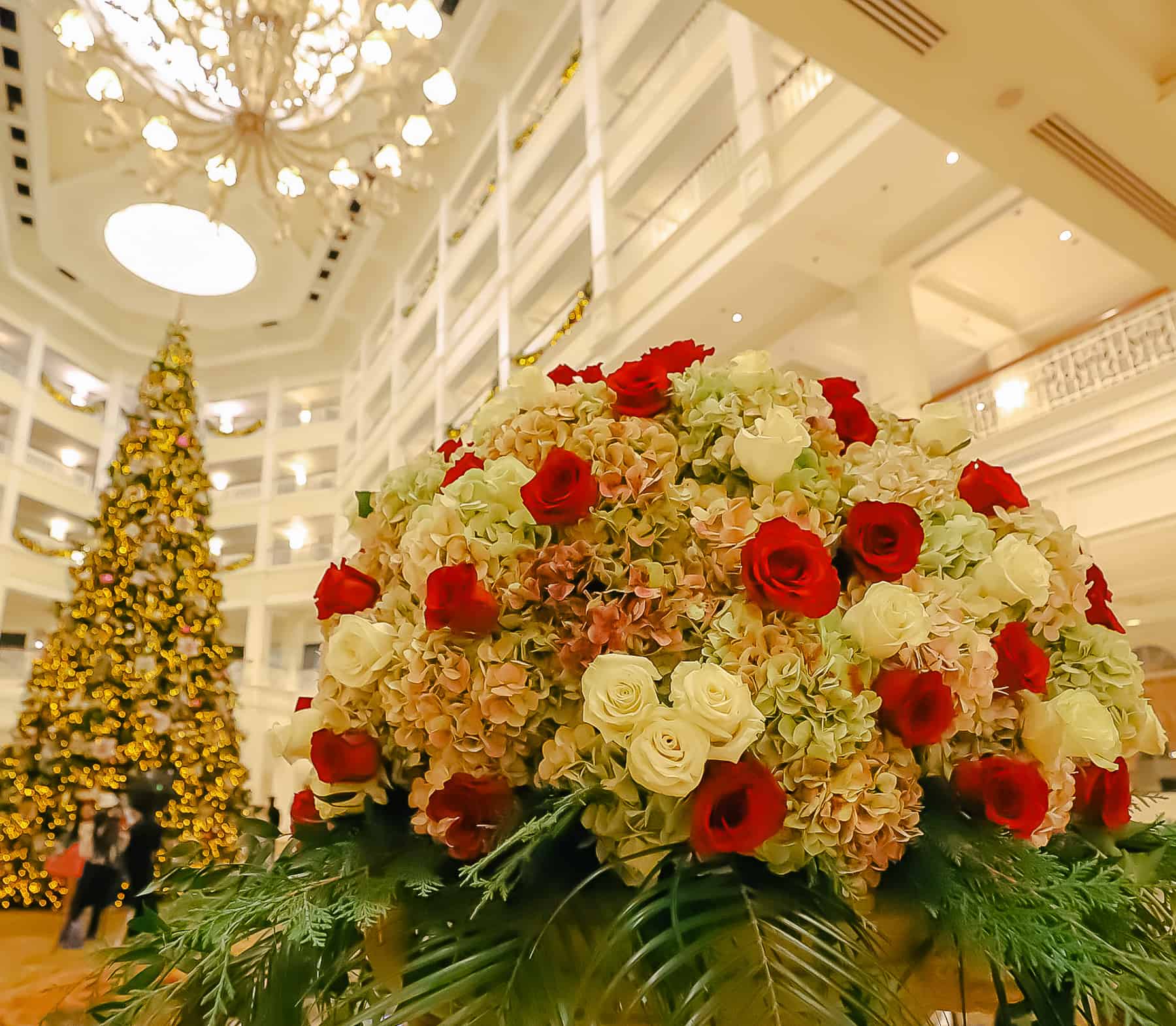 This picture of the flower arrangement is at an angle that shows a hidden Mickey made of white roses. 