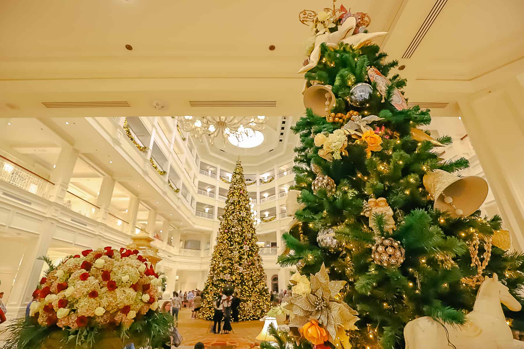 The front of the lobby at Grand Floridian showing the Christmas flower arrangement with the main tree in the background. 