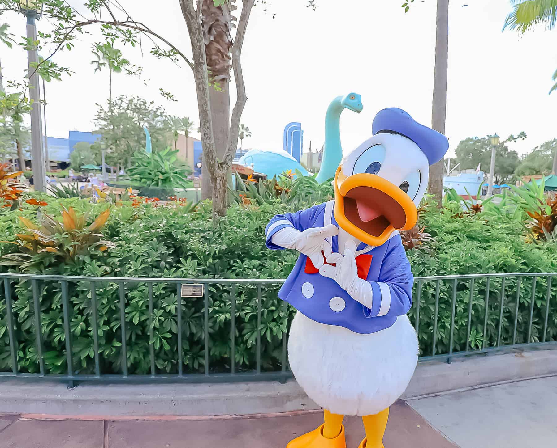 Donald Duck making a heart sign with his hands. 