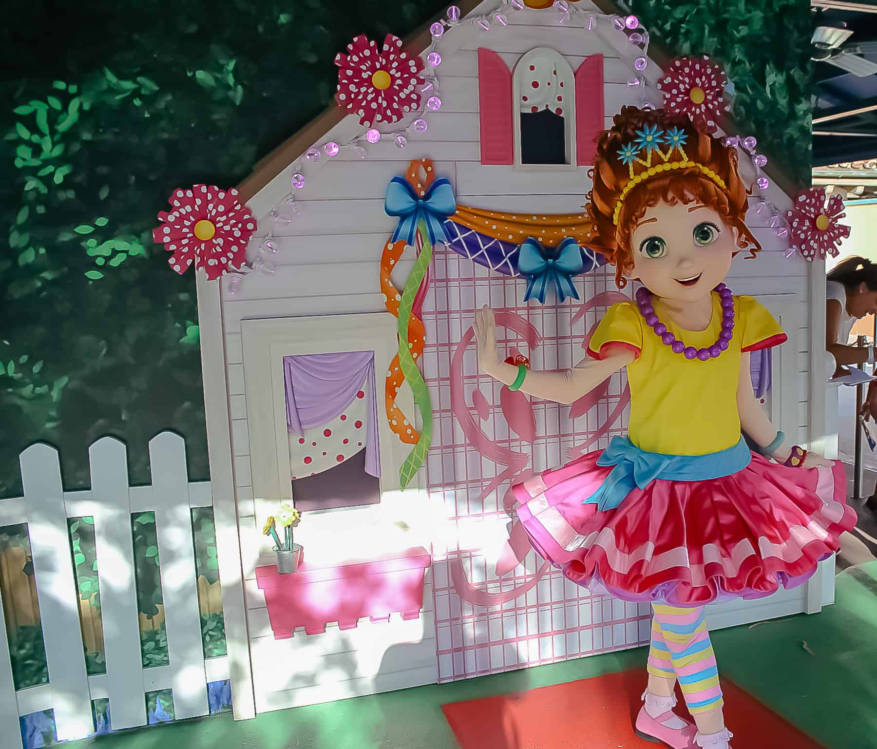 Fancy Nancy posing in front of a playhouse backdrop at Hollywood Studios. 