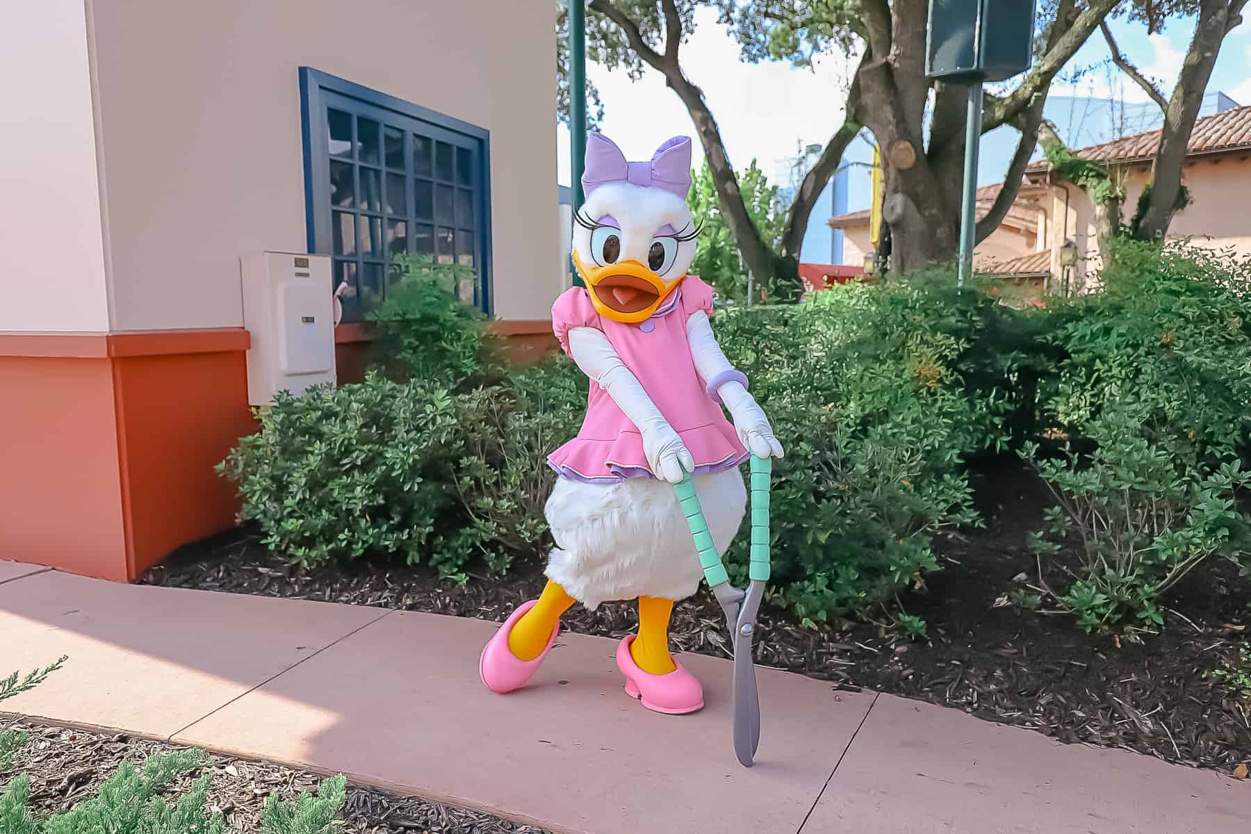 Daisy Duck posing with hedge clippers.