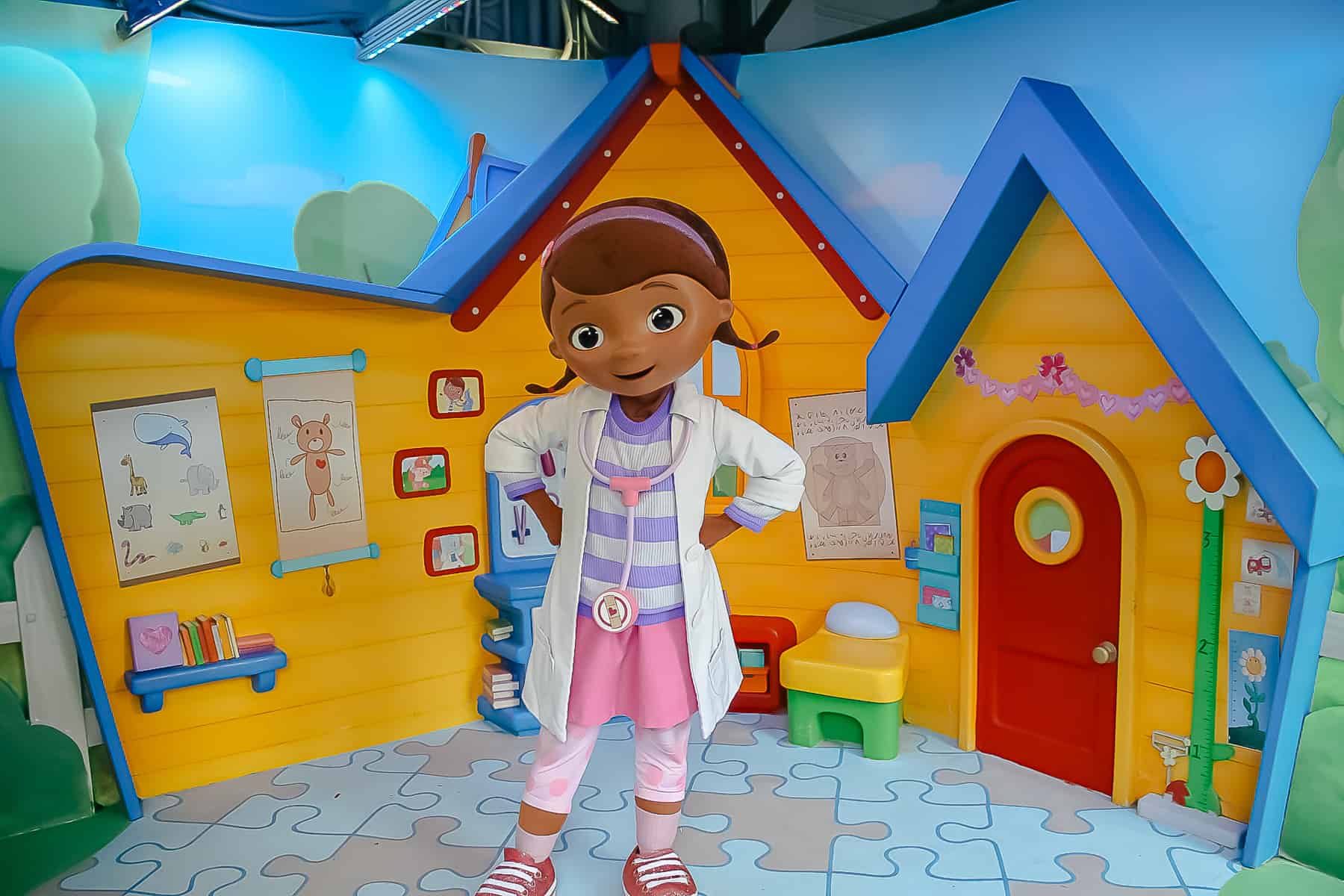 Doc McStuffins with her backdrop in the Disney Junior character area at Hollywood Studios. 