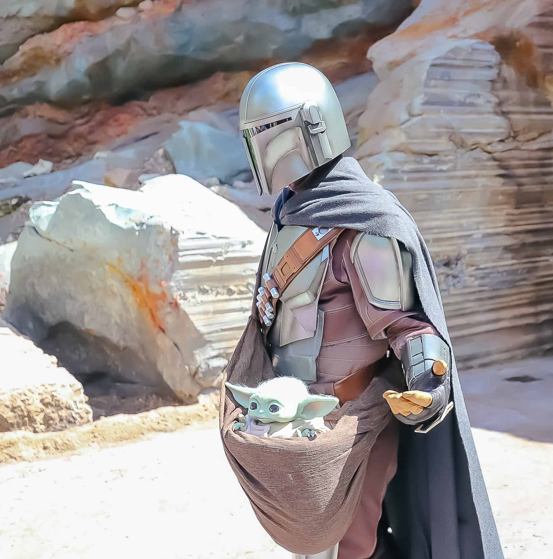 The Mandalorian and Grogu roaming Galaxy's Edge at Disney's Hollywood Studios. 