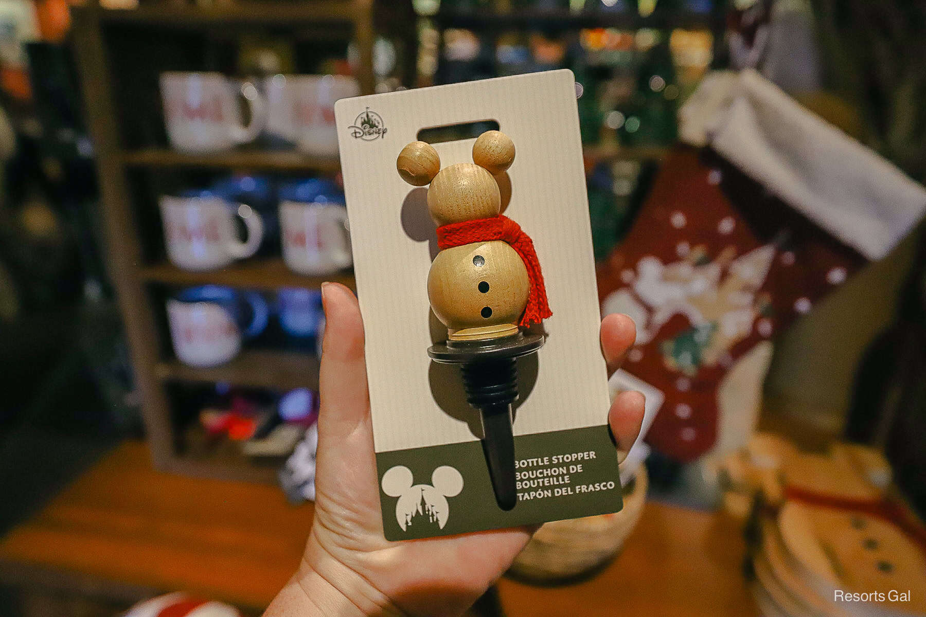 a wooden snowman Mickey shaped bottle topper with red scarf