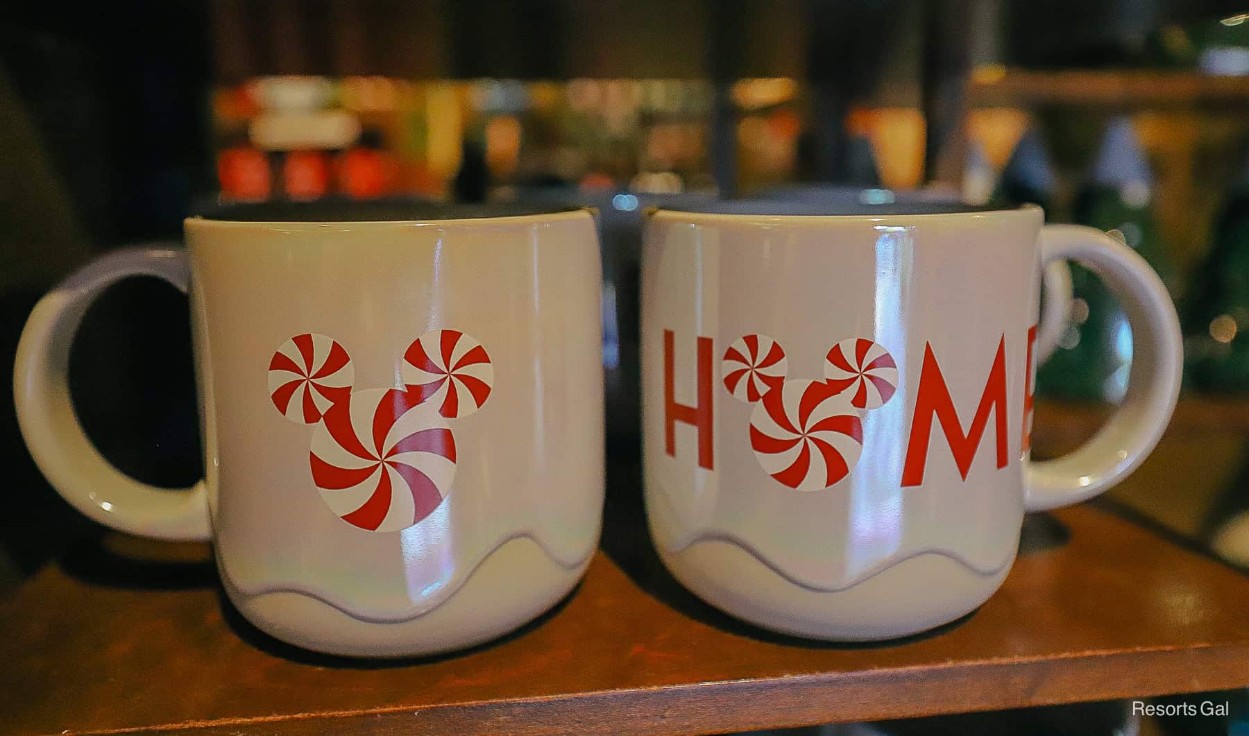 a mug sitting on a shelf that says Home with peppermint Mickey