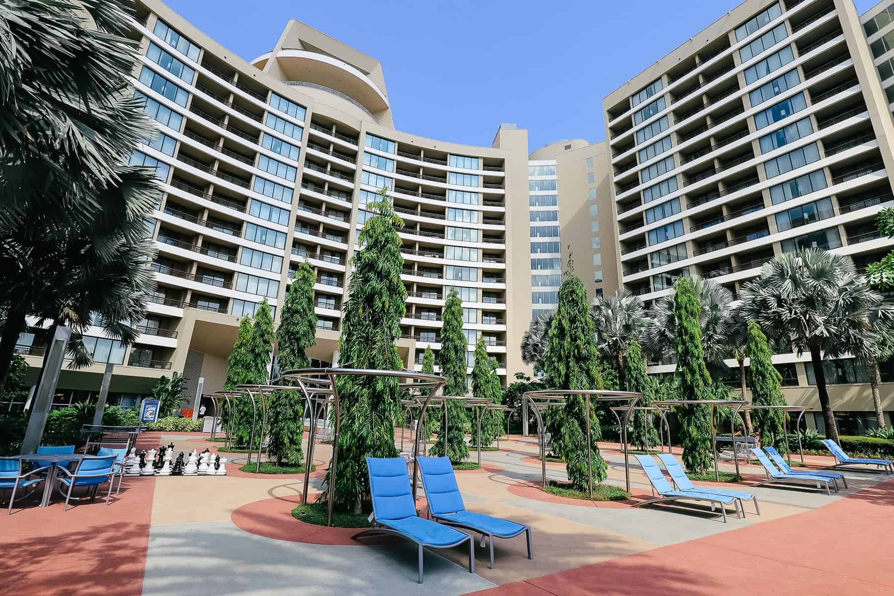 Bay Lake Tower's back side with sets of blue lounge chairs.