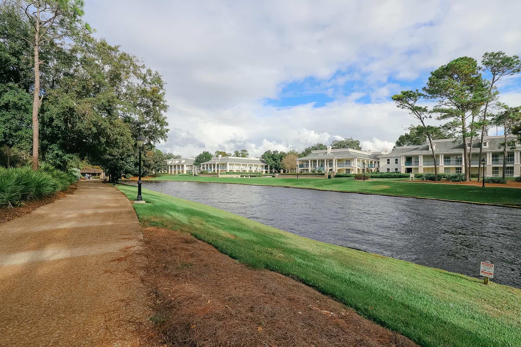 Port Orleans Riverside Resort walkway along the river with the mansions sitting on the opposite side. 