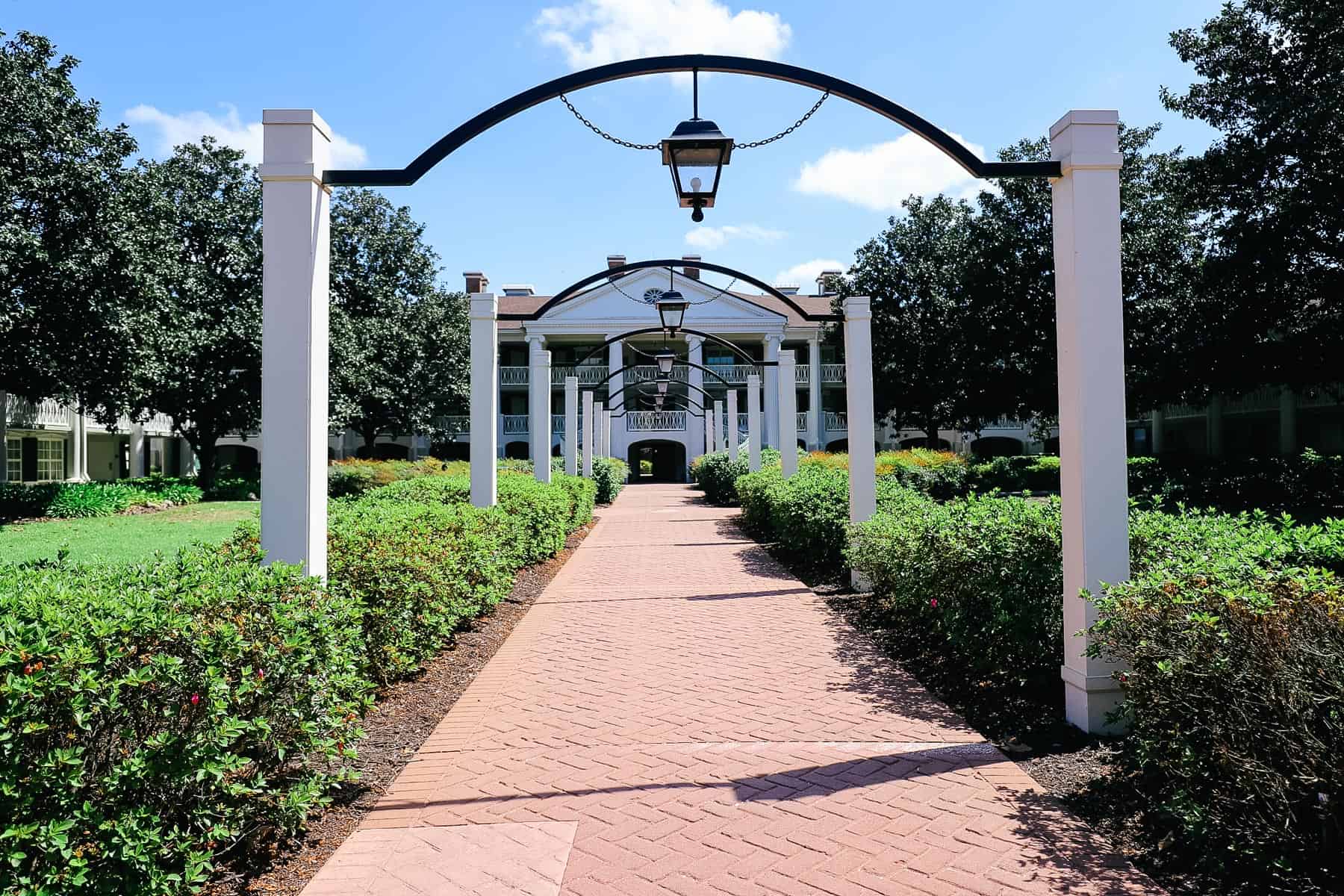 a walkway with pavers up to a mansion at Port Orleans Riverside 