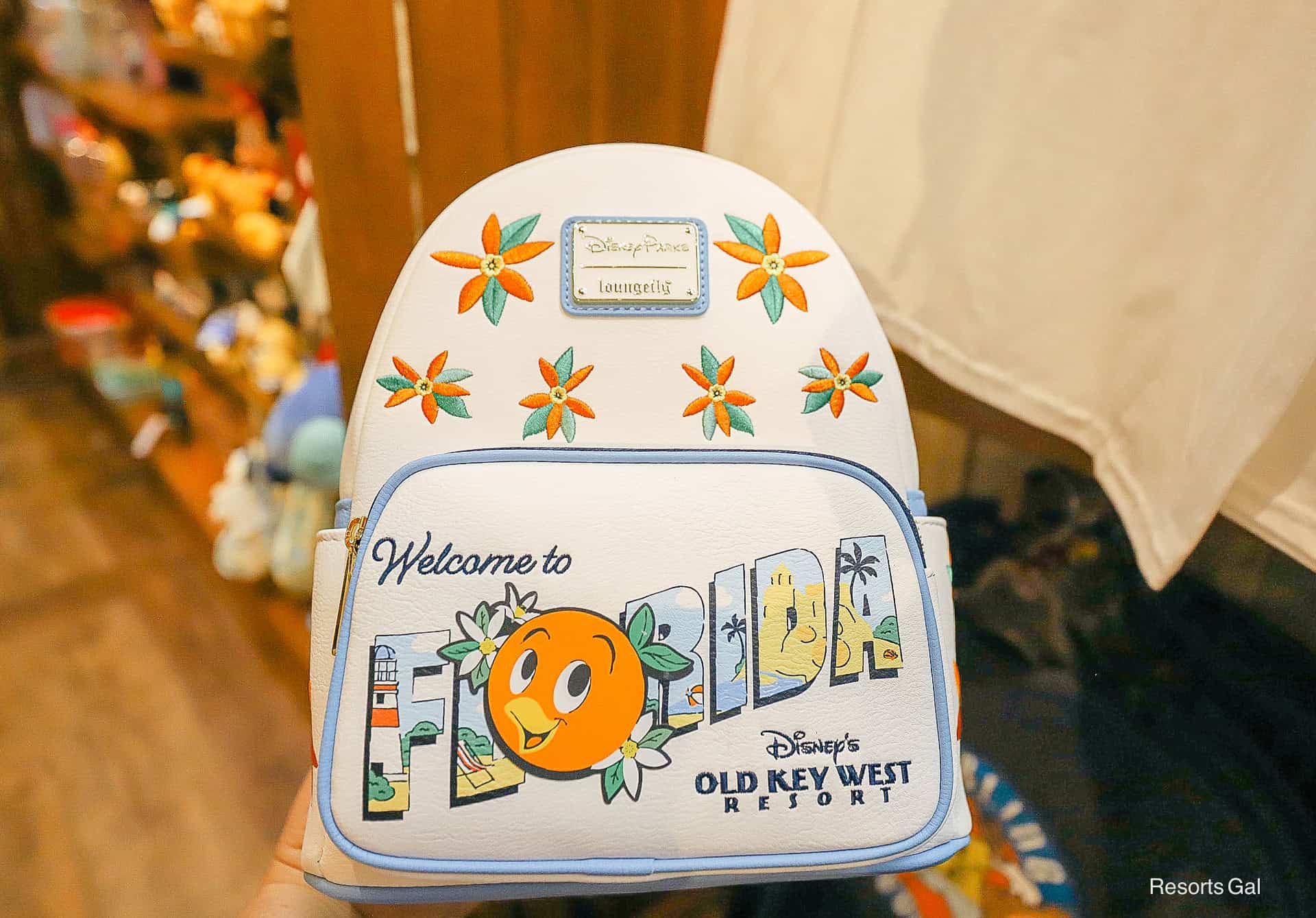 Disney Parks Loungefly backpack for Old Key West in white with orange, light blues, and yellows