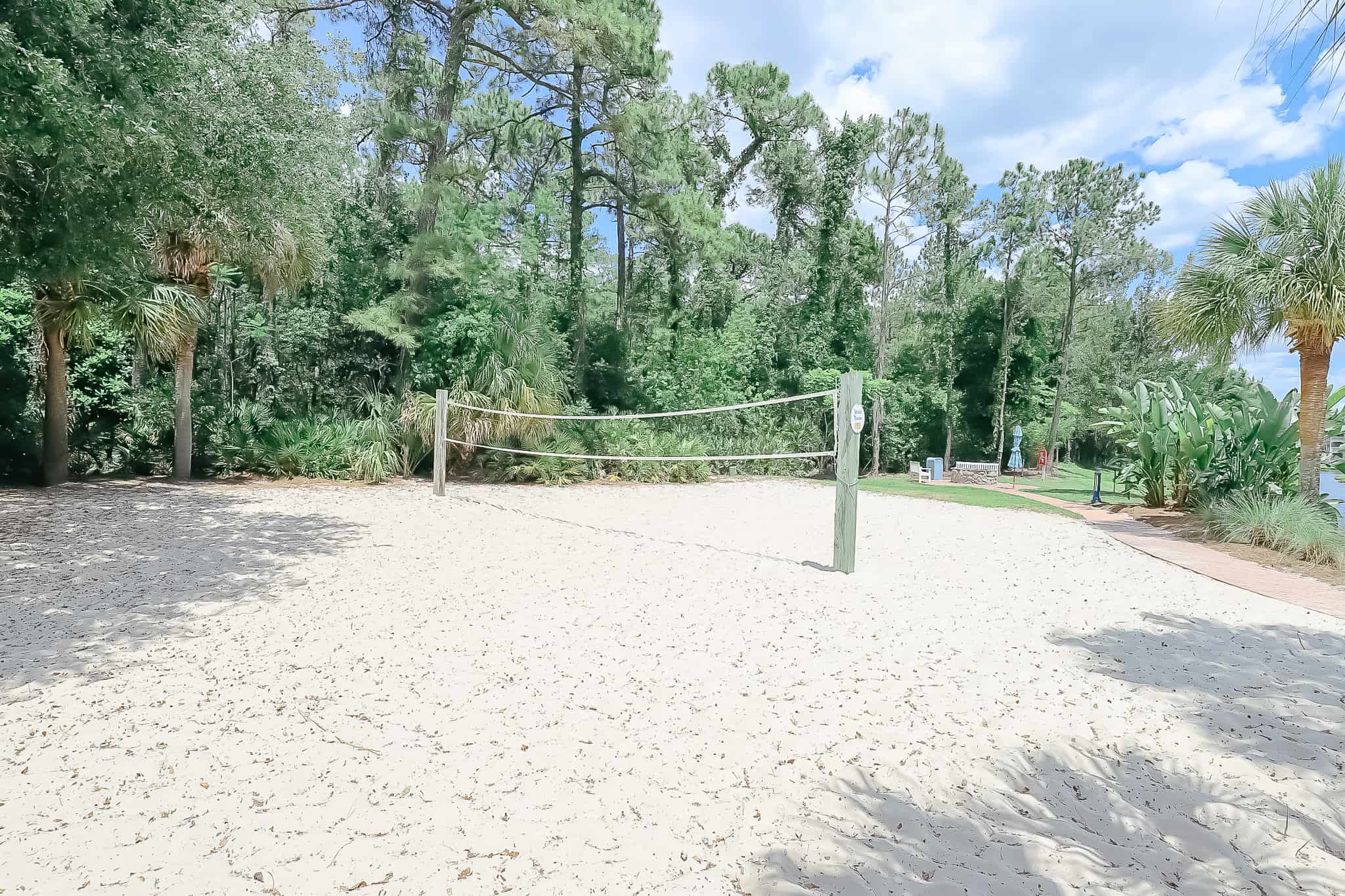 volleyball on a sand court near the pool