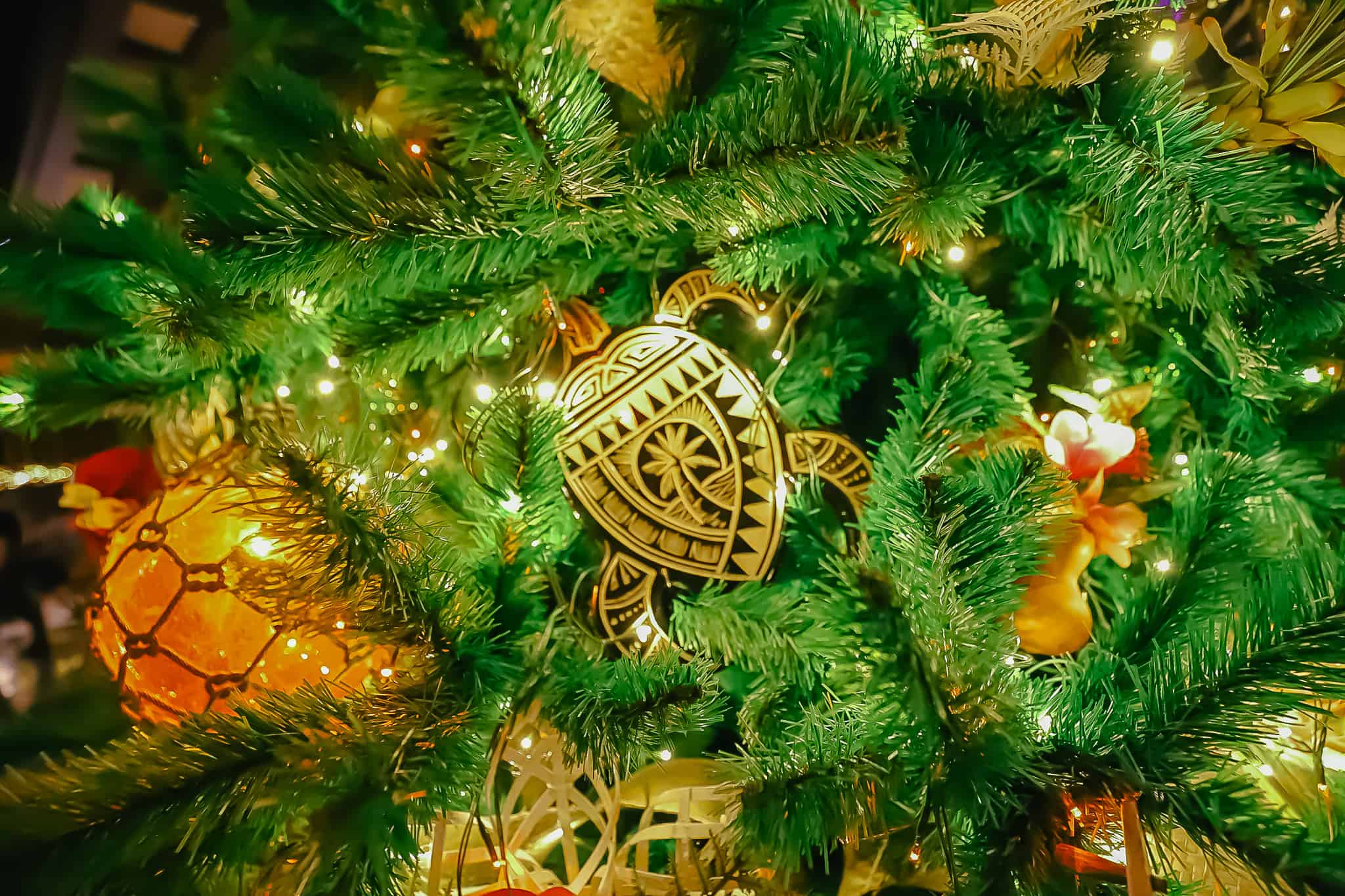 An ornament that's shaped like a turtle with a palm tree on the shell. 