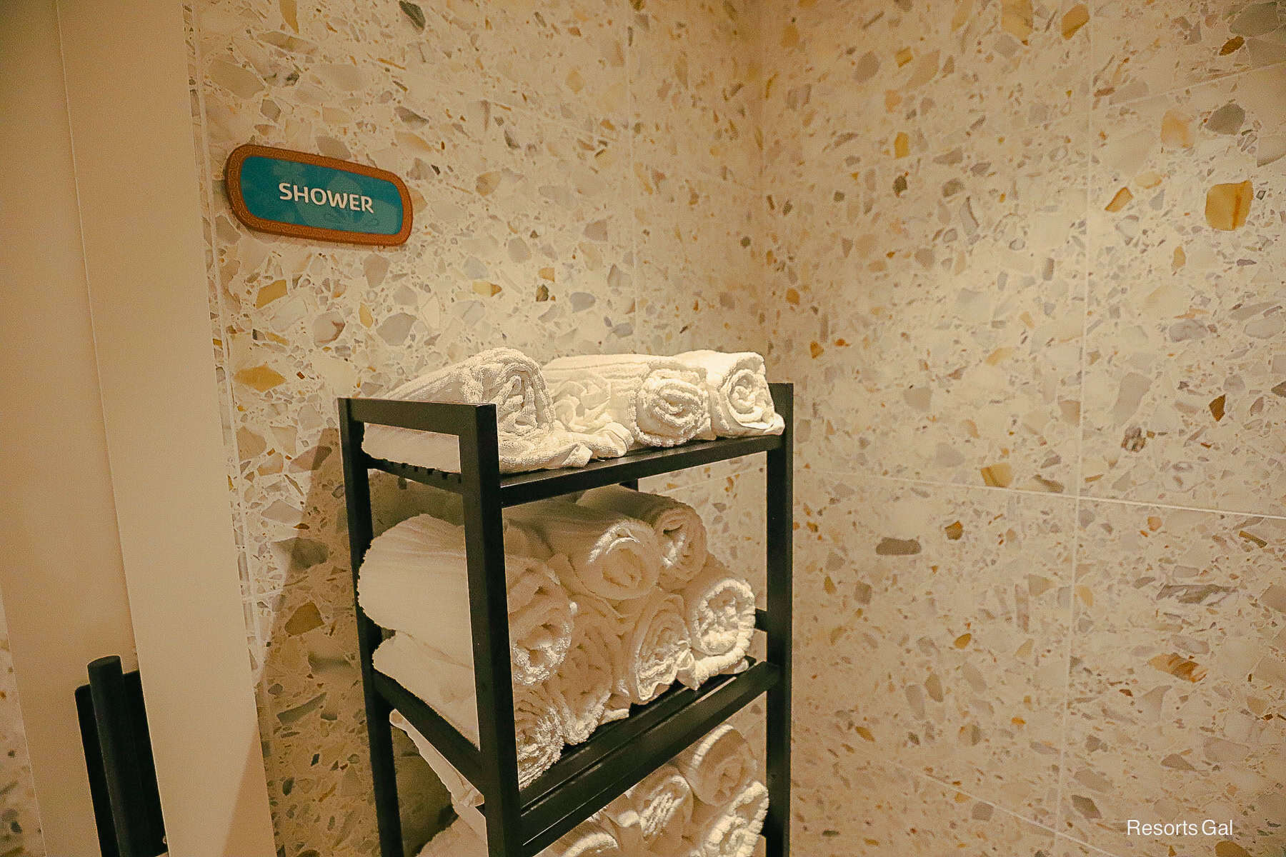 a rack with complimentary towels for guests to use at the pool at the Polynesian Island Tower 