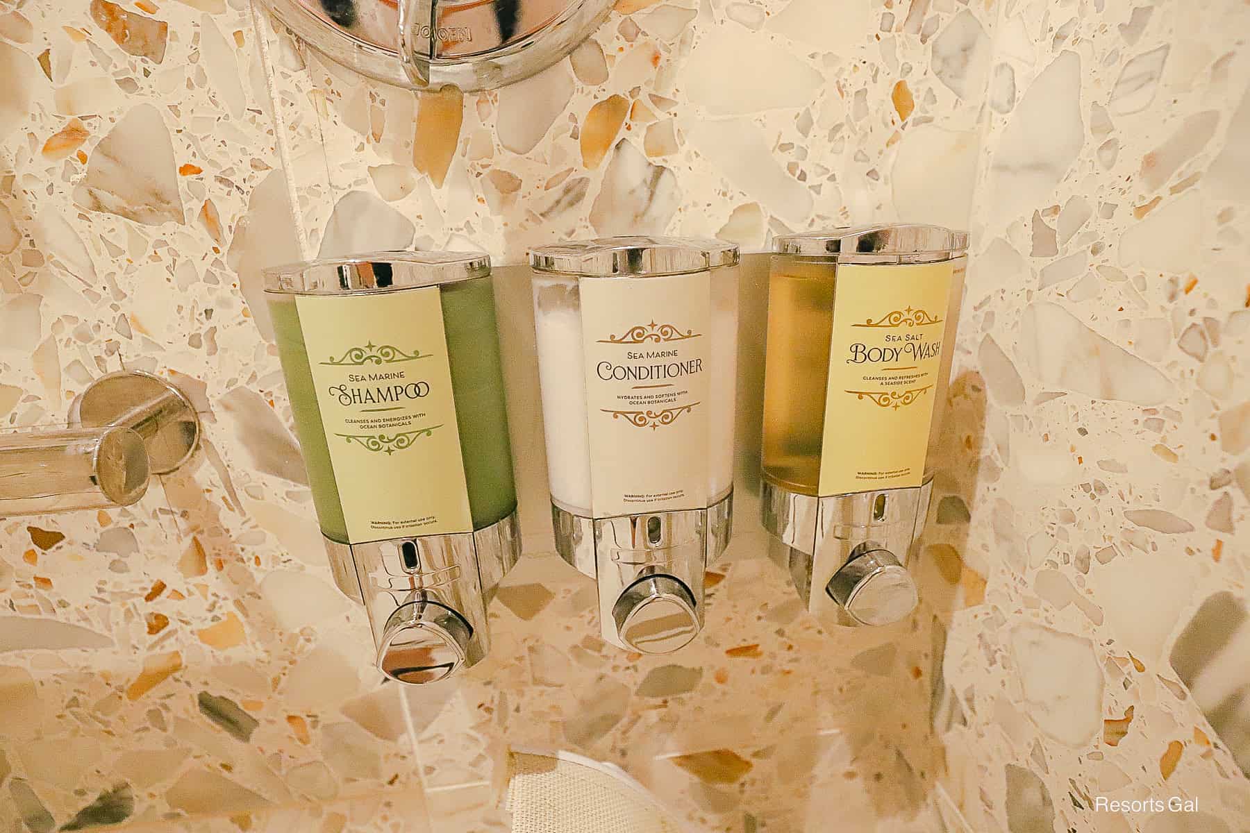 a shampoo, conditioner, and body wash in the pool shower room 