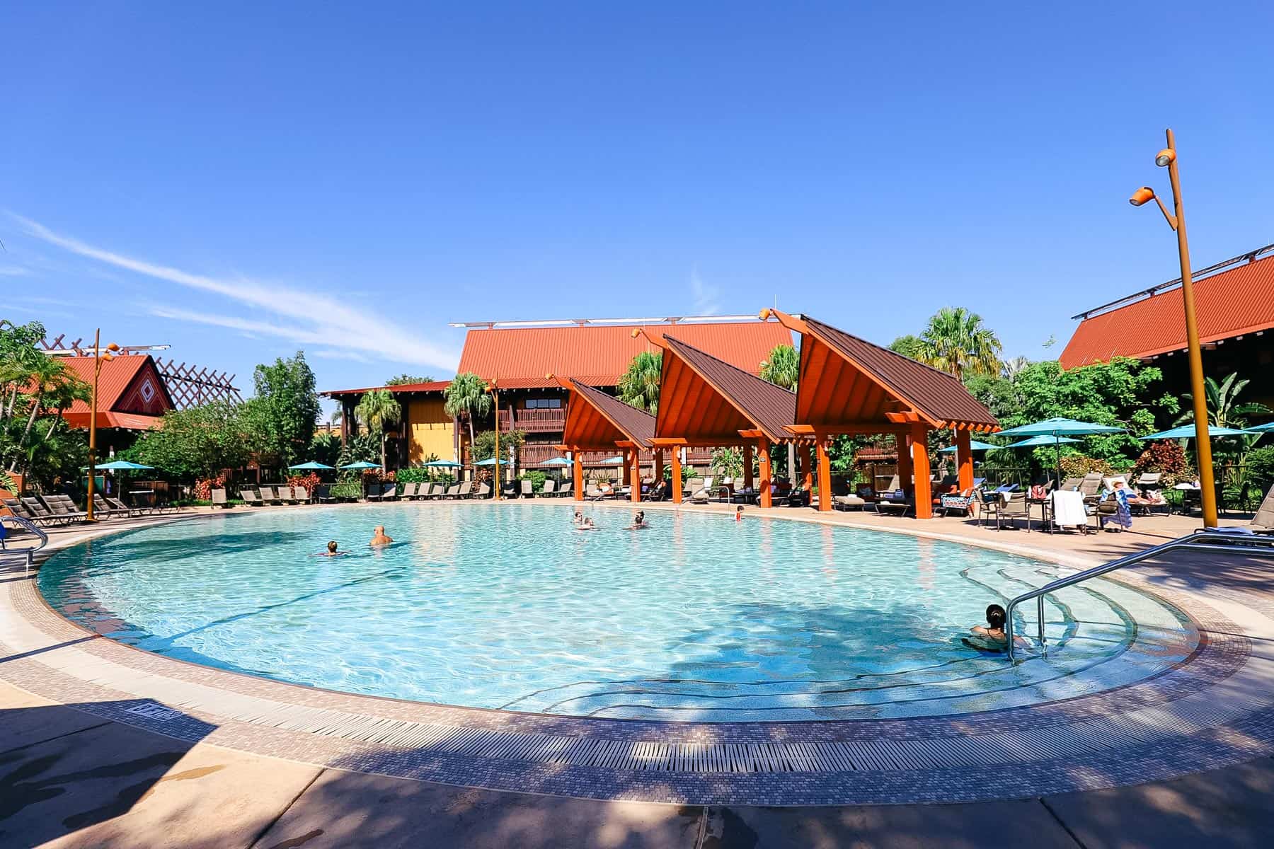 The Oasis pool's oval shape with cabanas in the background.