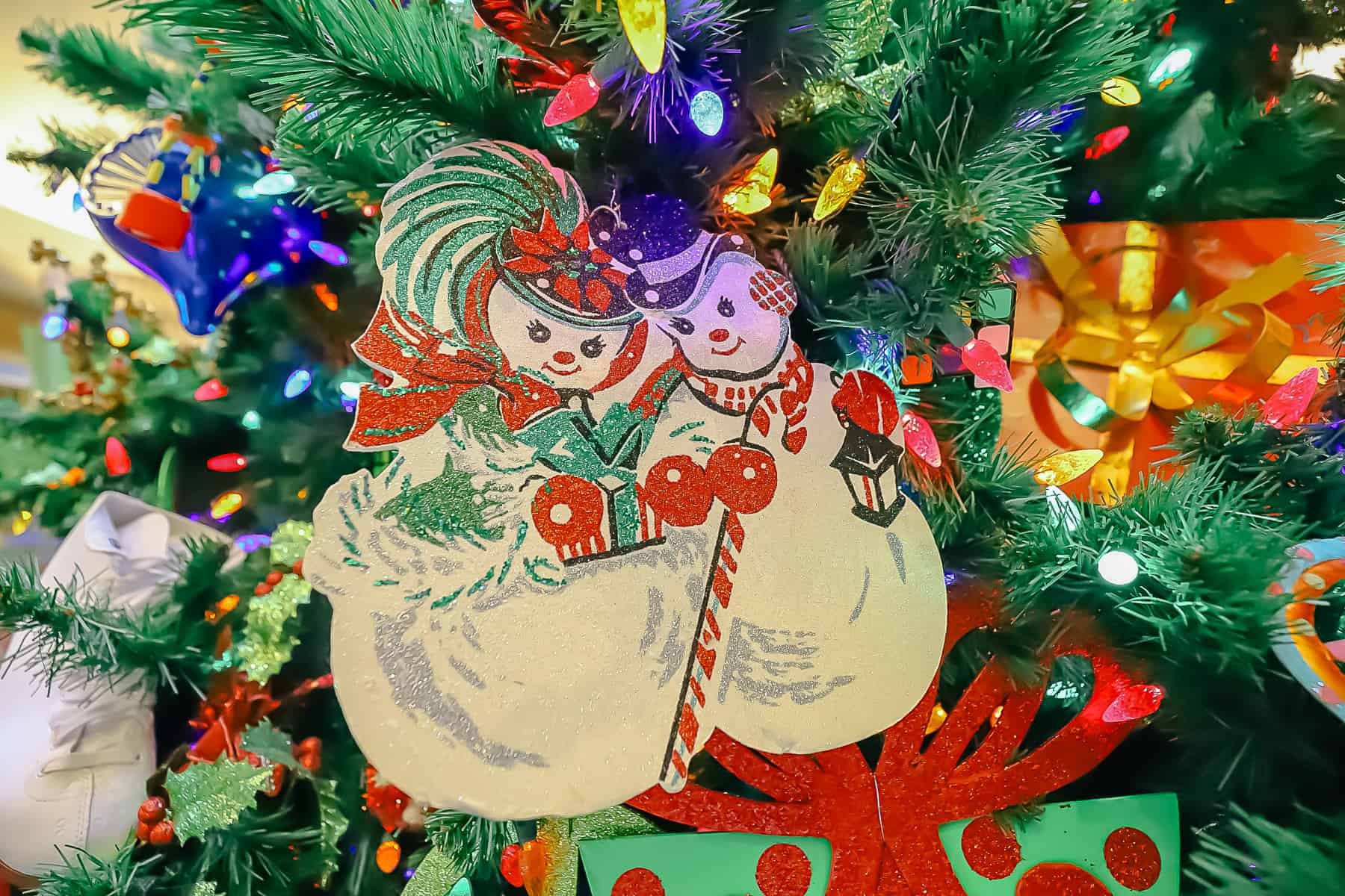 Mr. and Mrs. Snowman ornaments in the tree at Pop Century 