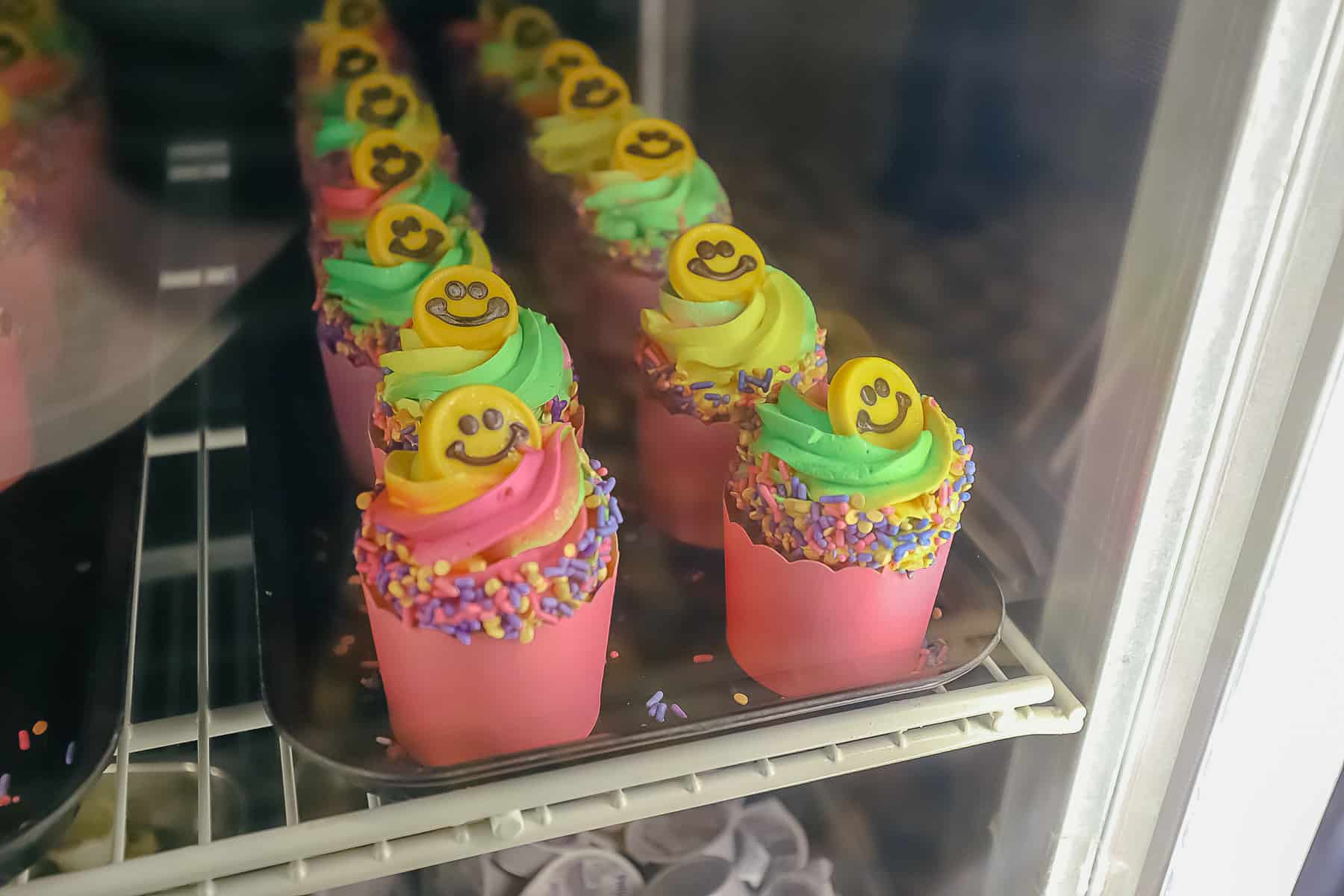 cupcakes with pink wrappers and yellow smiley faces 