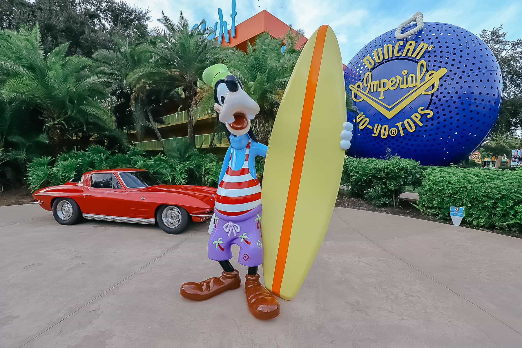 Goofy with a surfboard and corvette in a fun photo opp area at Pop Century. 