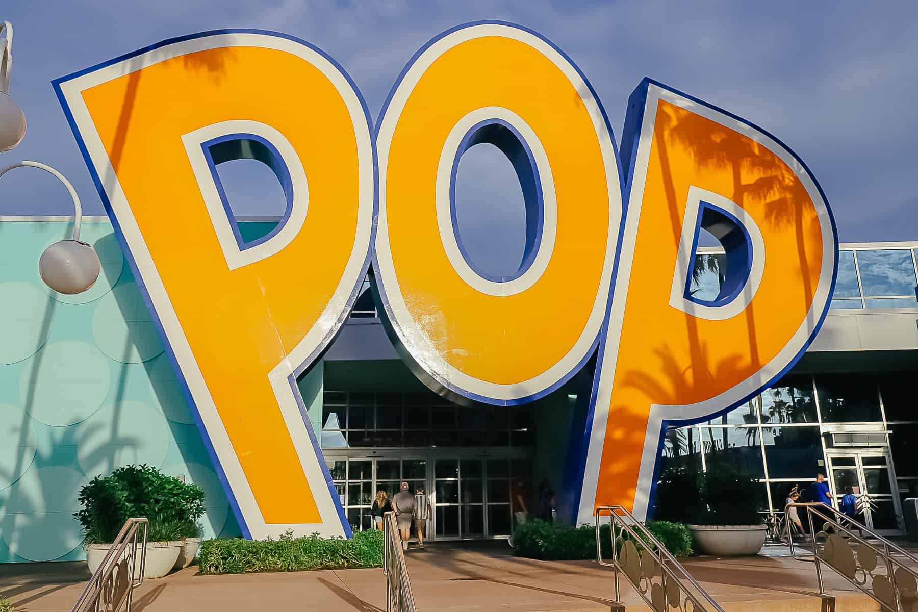 a giant sign with yellow letters that says POP for Pop Century 