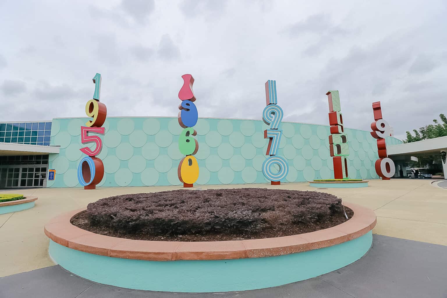 outside the front entrance of Pop Century each sign represents one of the decades at the resort