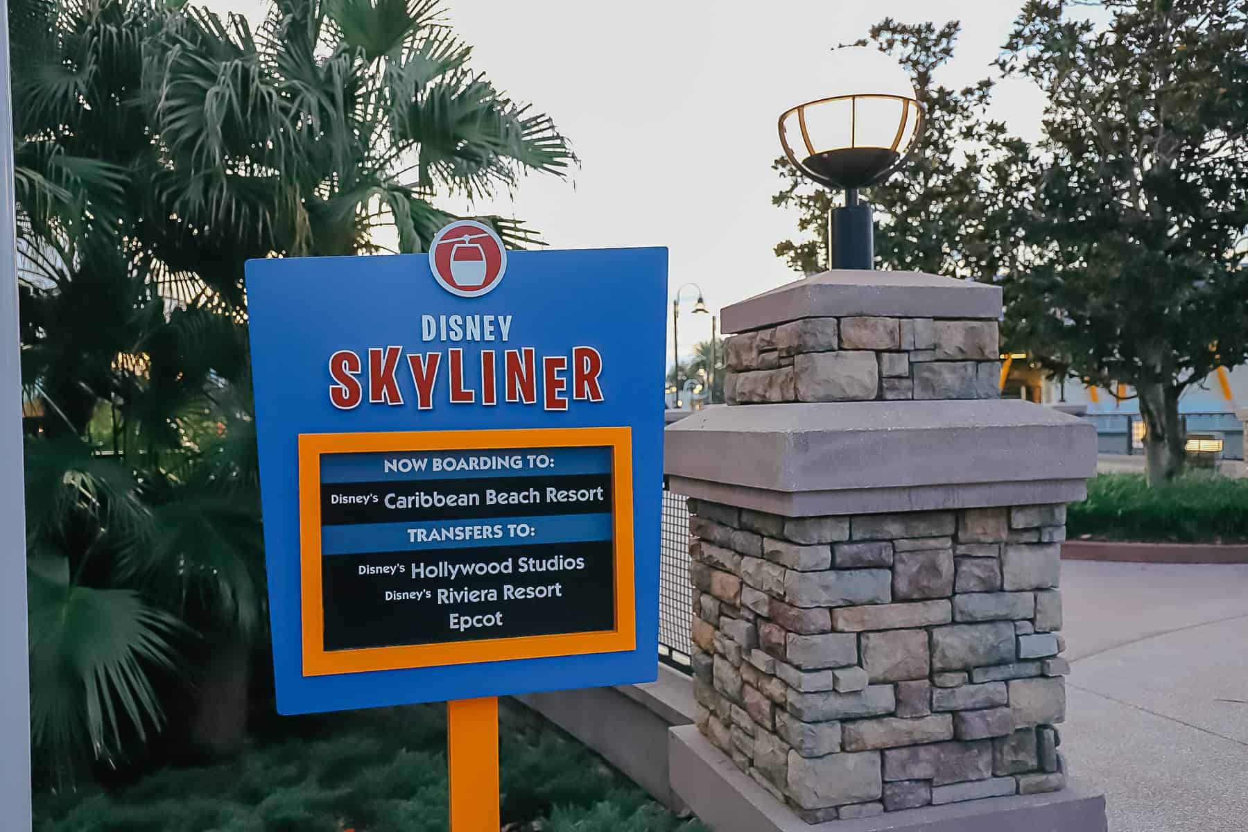 a sign for the Disney Skyliner that tells it's going to Caribbean Beach with transfers 