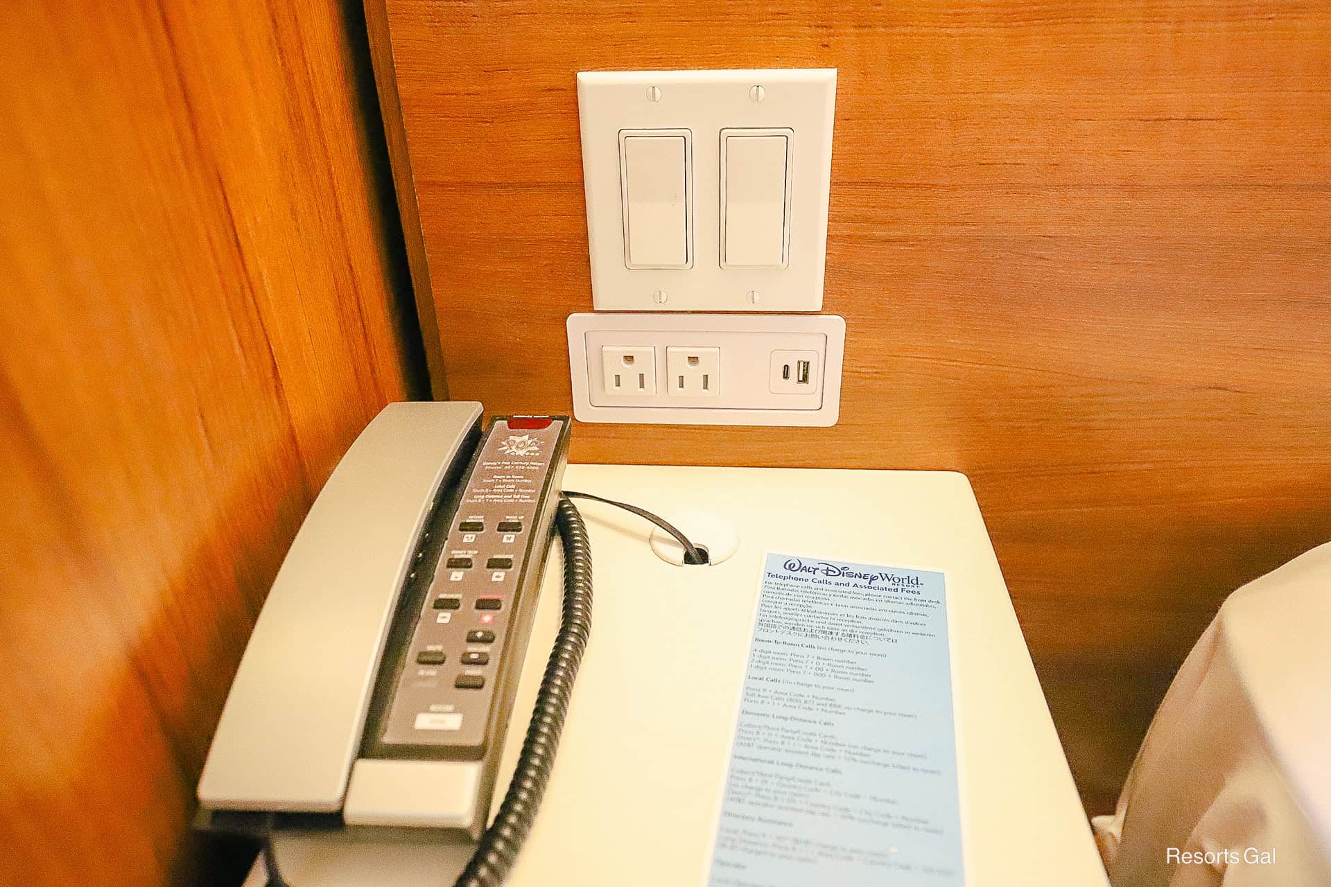 a nightstand with outlets by the bed in the room at Pop Century 
