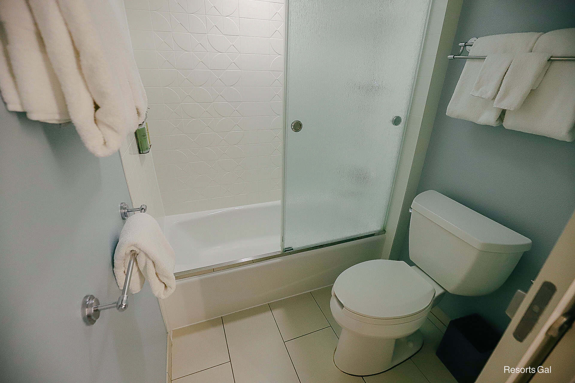 the bathtub and shower in the rooms at Disney's Pop Century Resort with glass shower doors 
