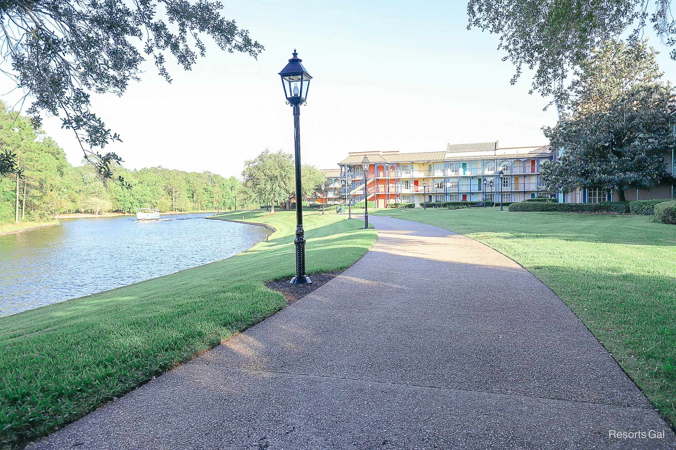 a shaded sidewalk between the Sassagoula River at Disney and the French Quarter Resort 