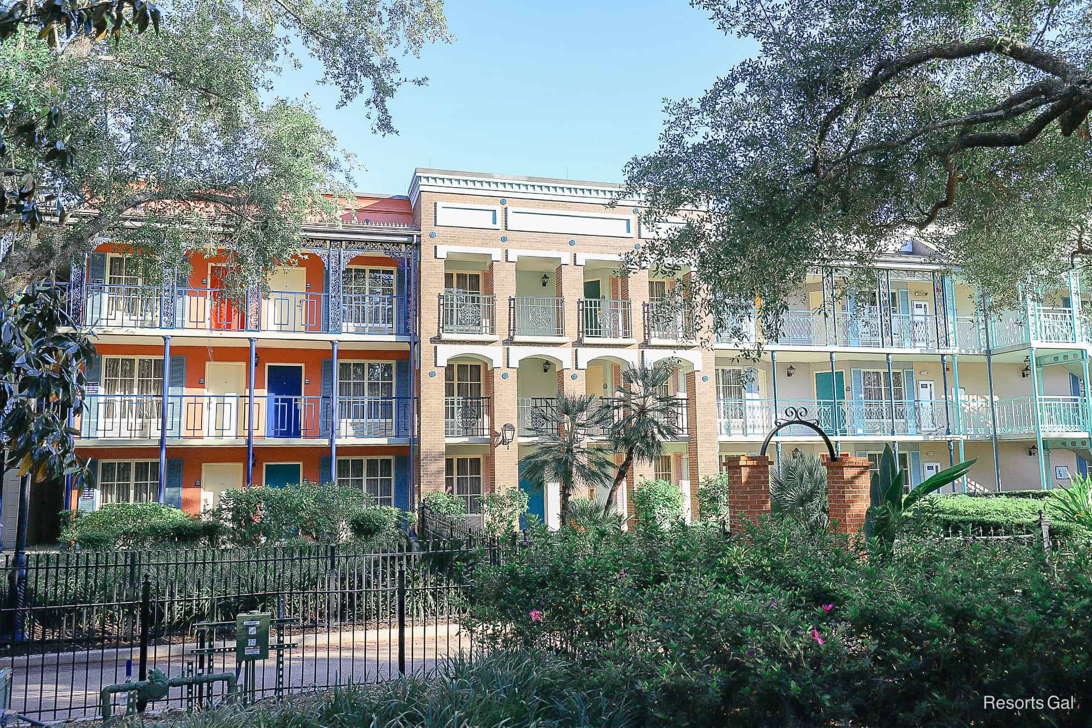 a set of buildings with the sun casting rays on them late in the afternoon 