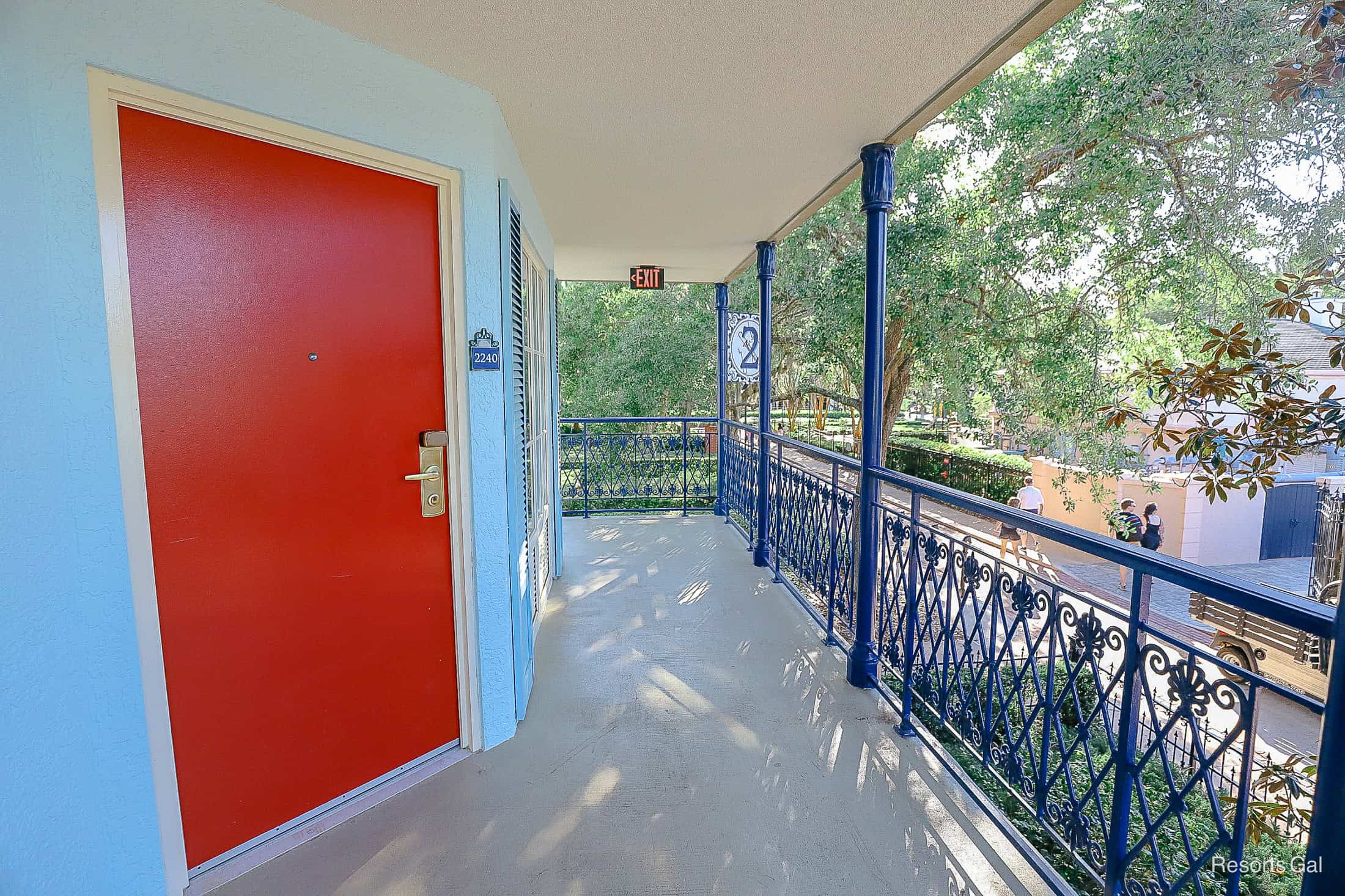 a blue building with bright red doors 