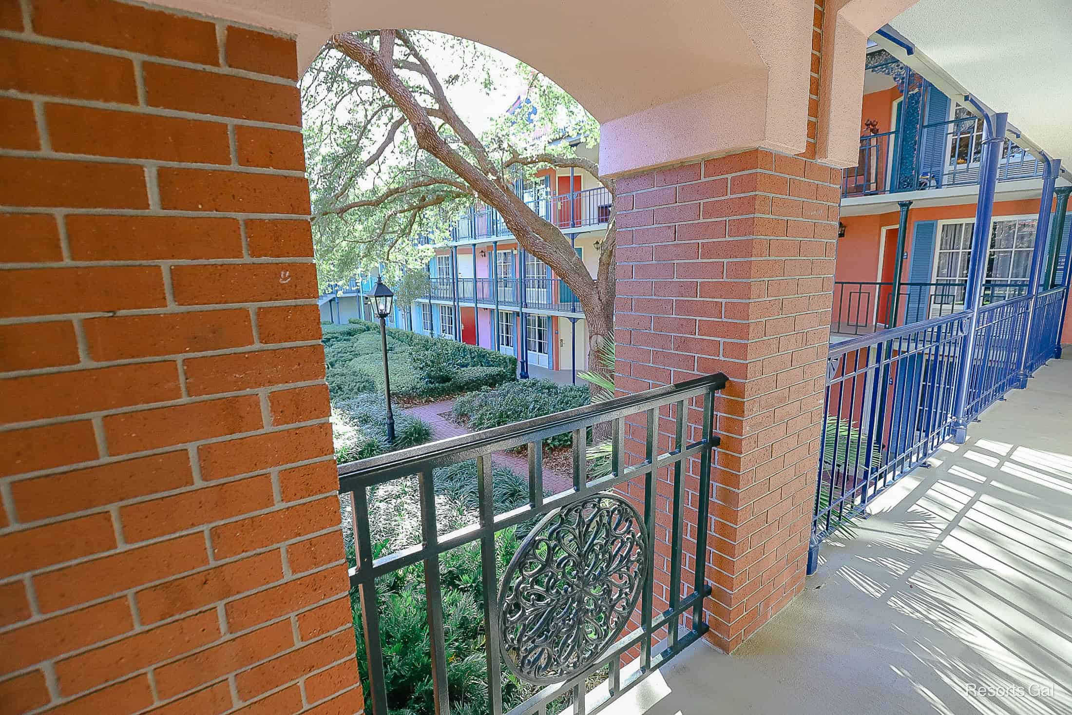 decorative iron railings between a brick facade on the second floor 