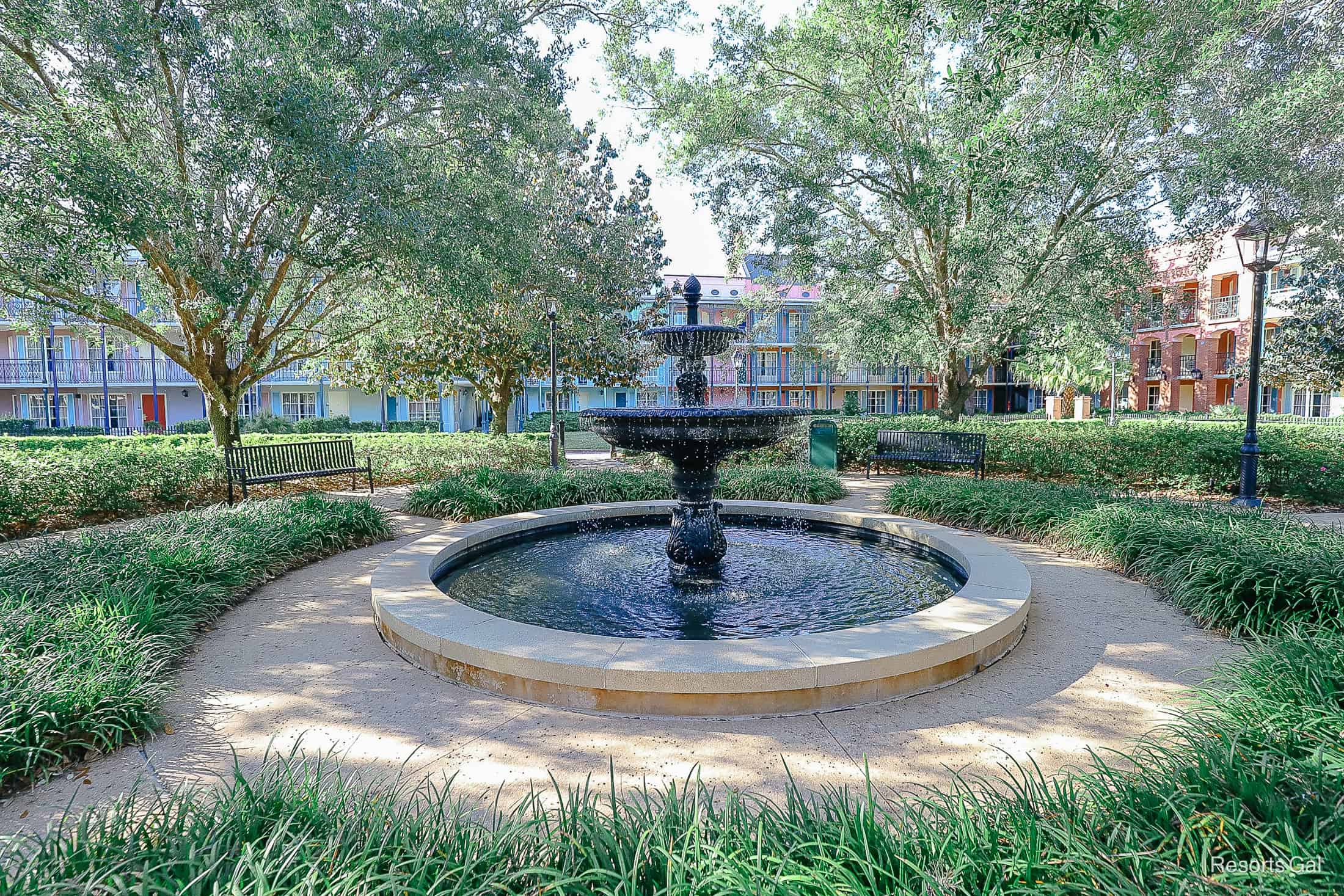 a fountain in the center of buildings one, two, and three 