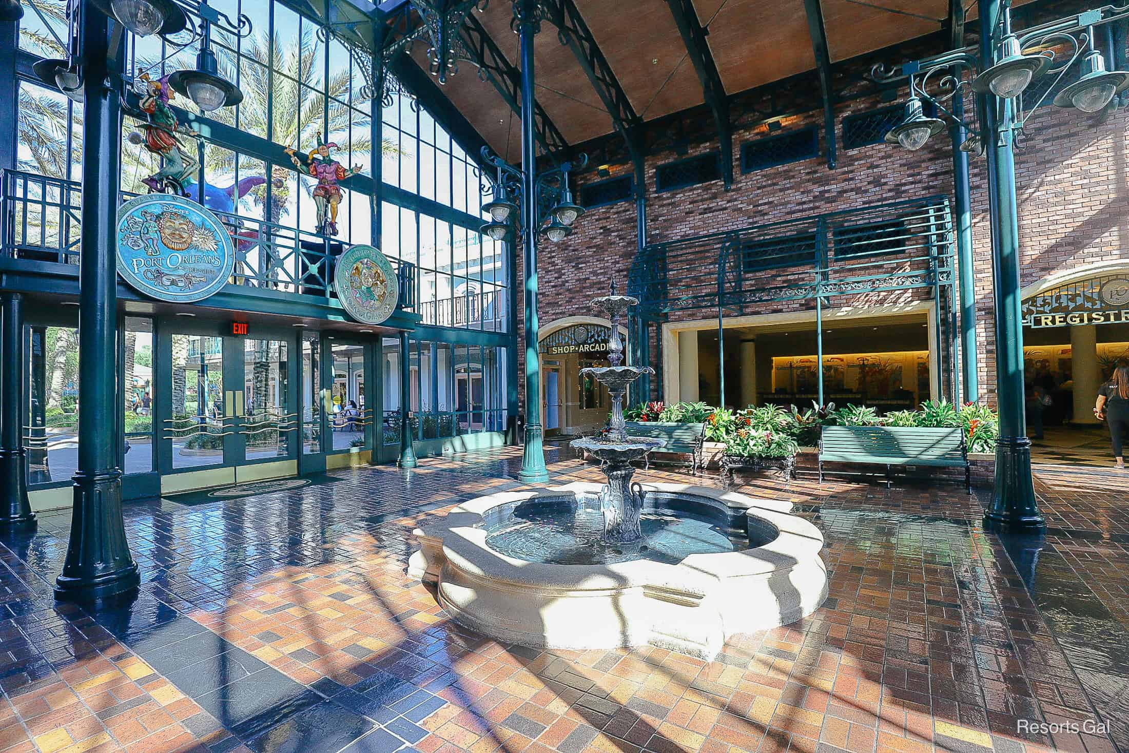 a side view of the lobby at Port Orleans French Quarter with a fountain in the center 