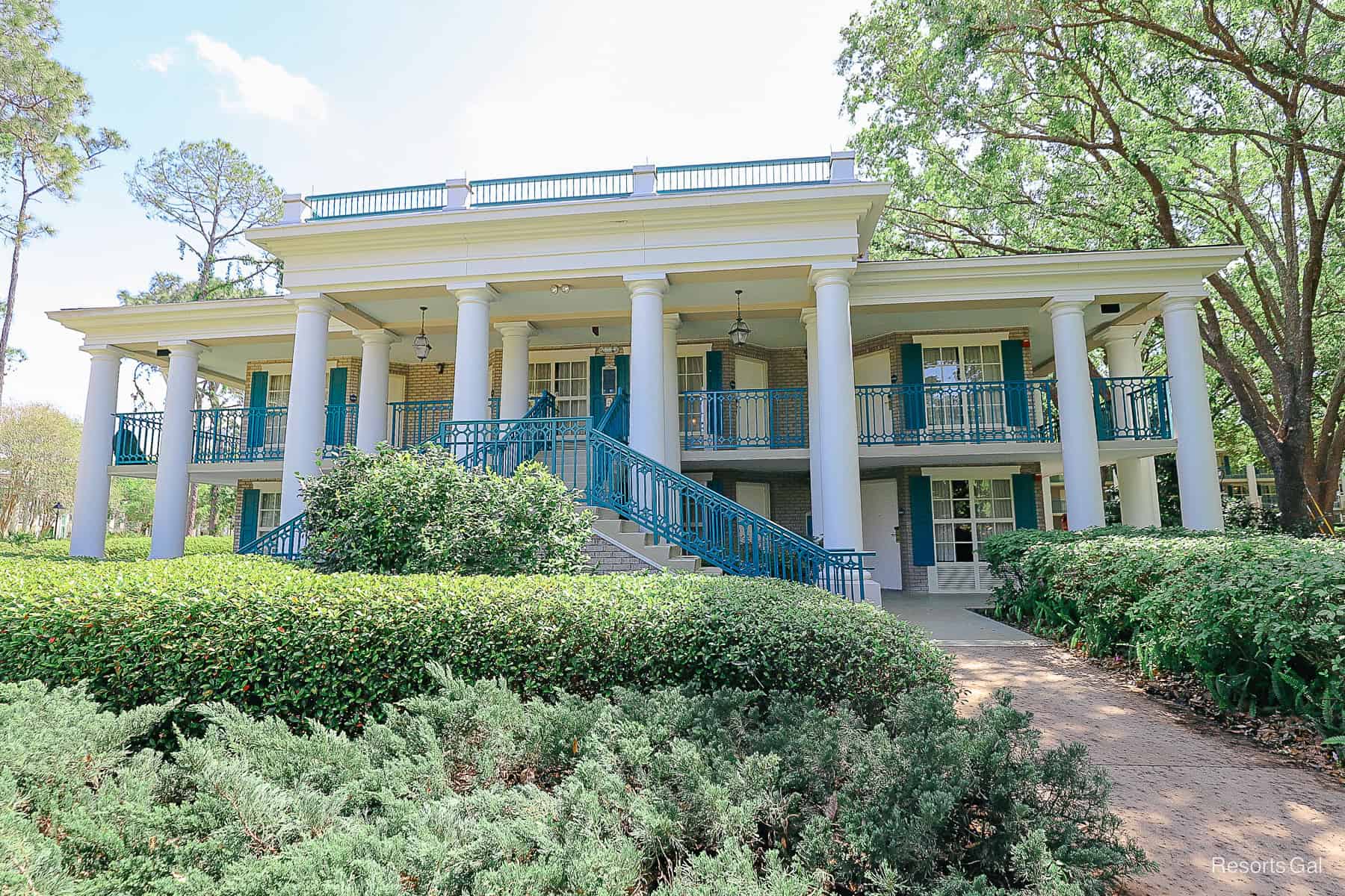 these buildings are white with a turquoise trim and have brick accents 