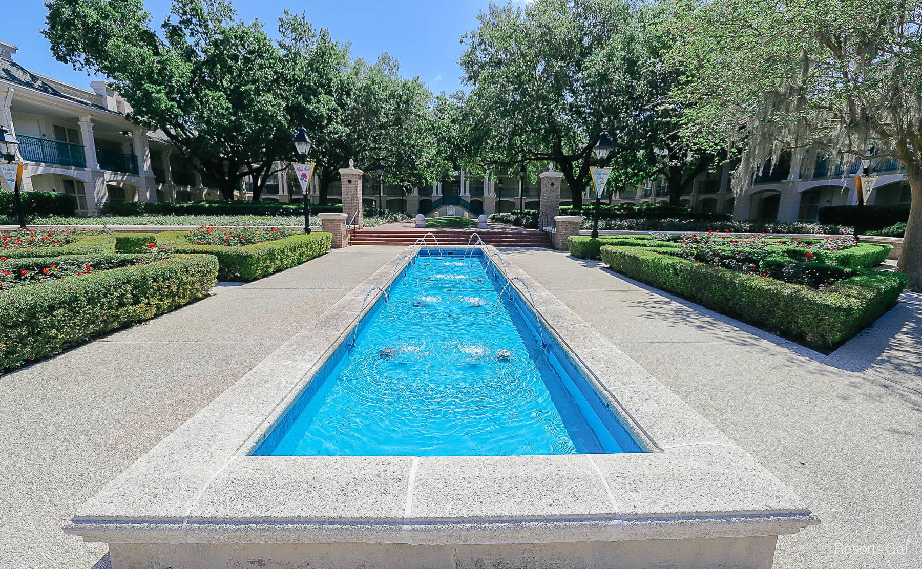 a long blue rectangle shaped fountain 