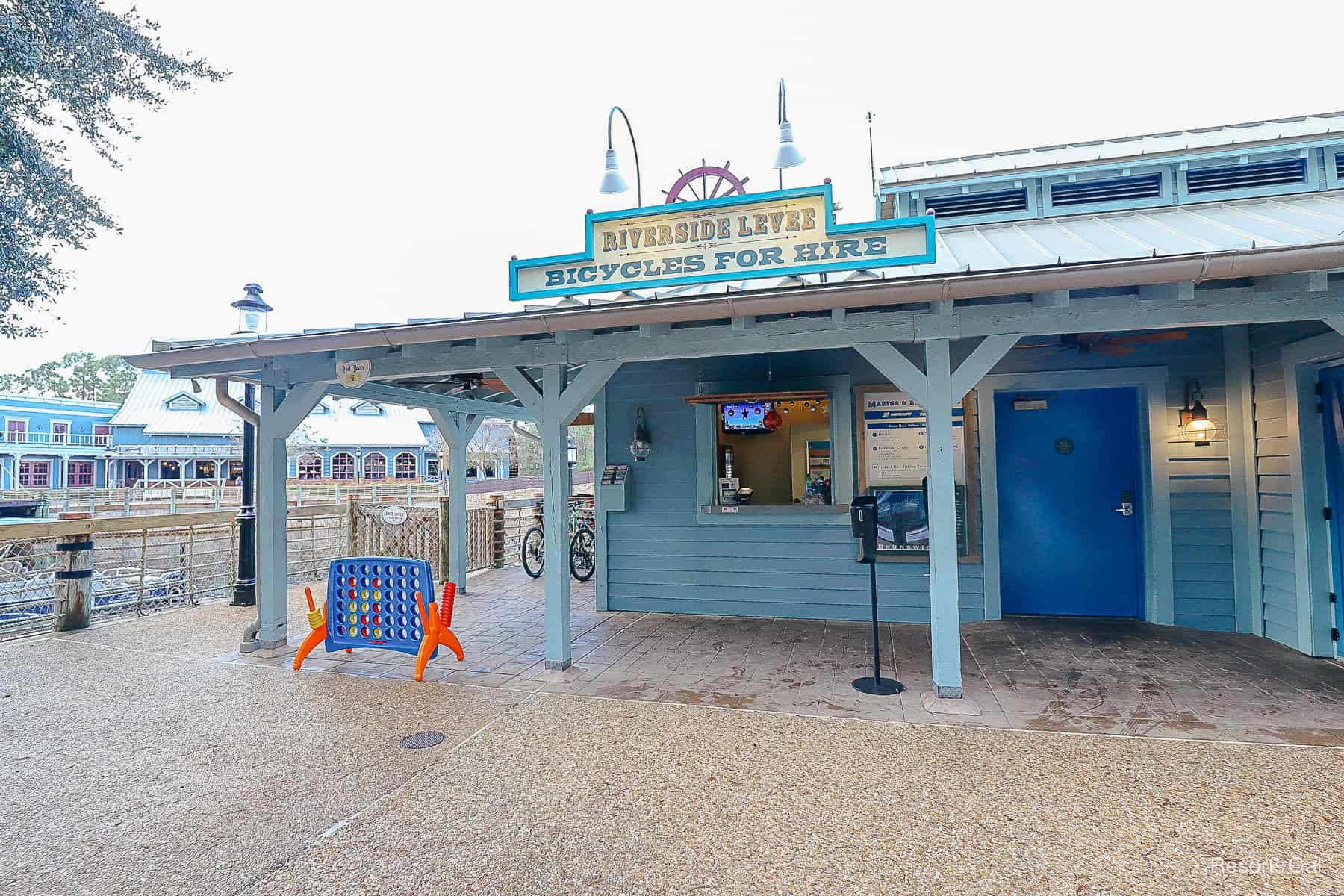 a blue building with a sign above it that says Riverside Levee bicycles for hire 