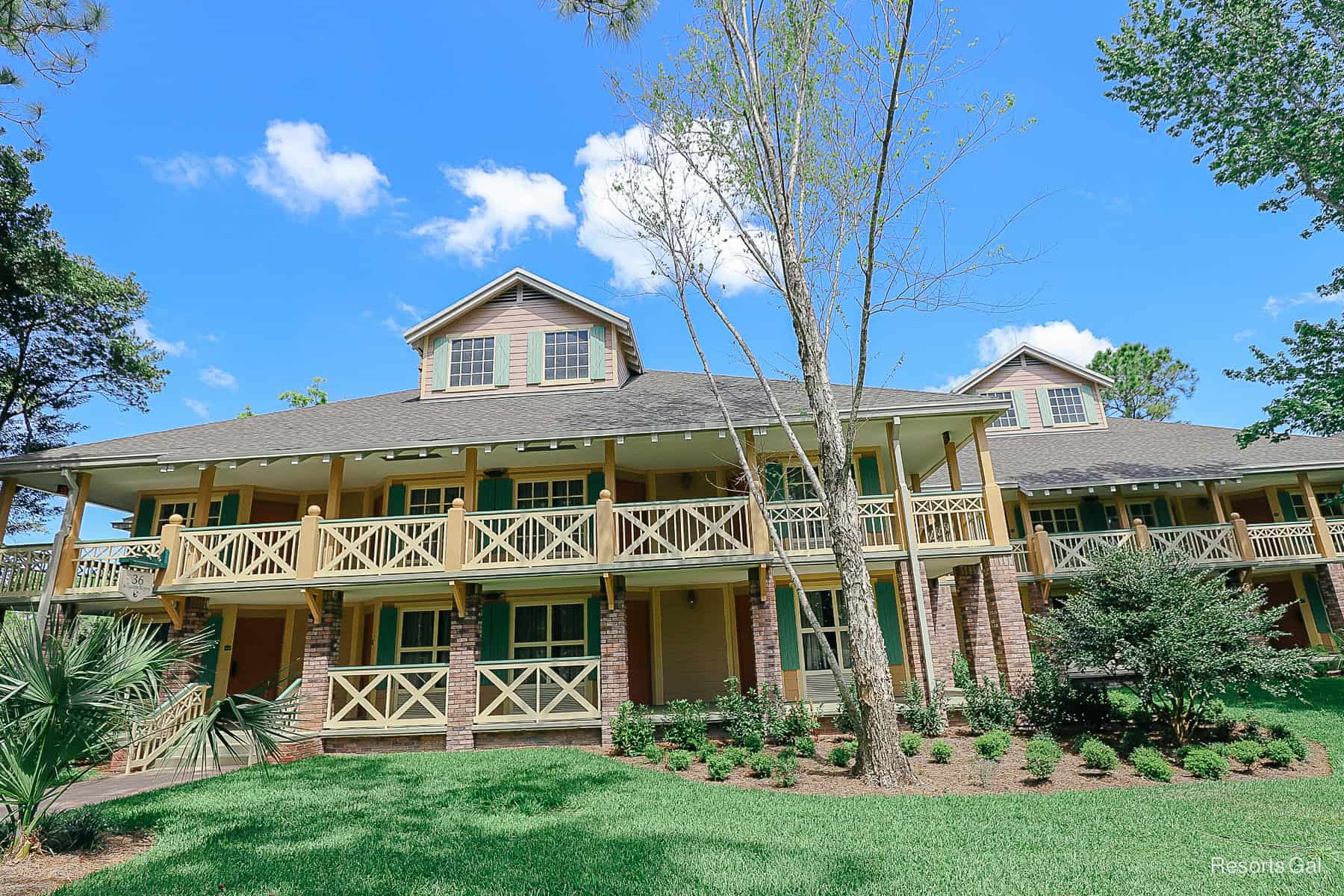 a building in the Alligator Bayou that's tan with brick columns and sage trime 