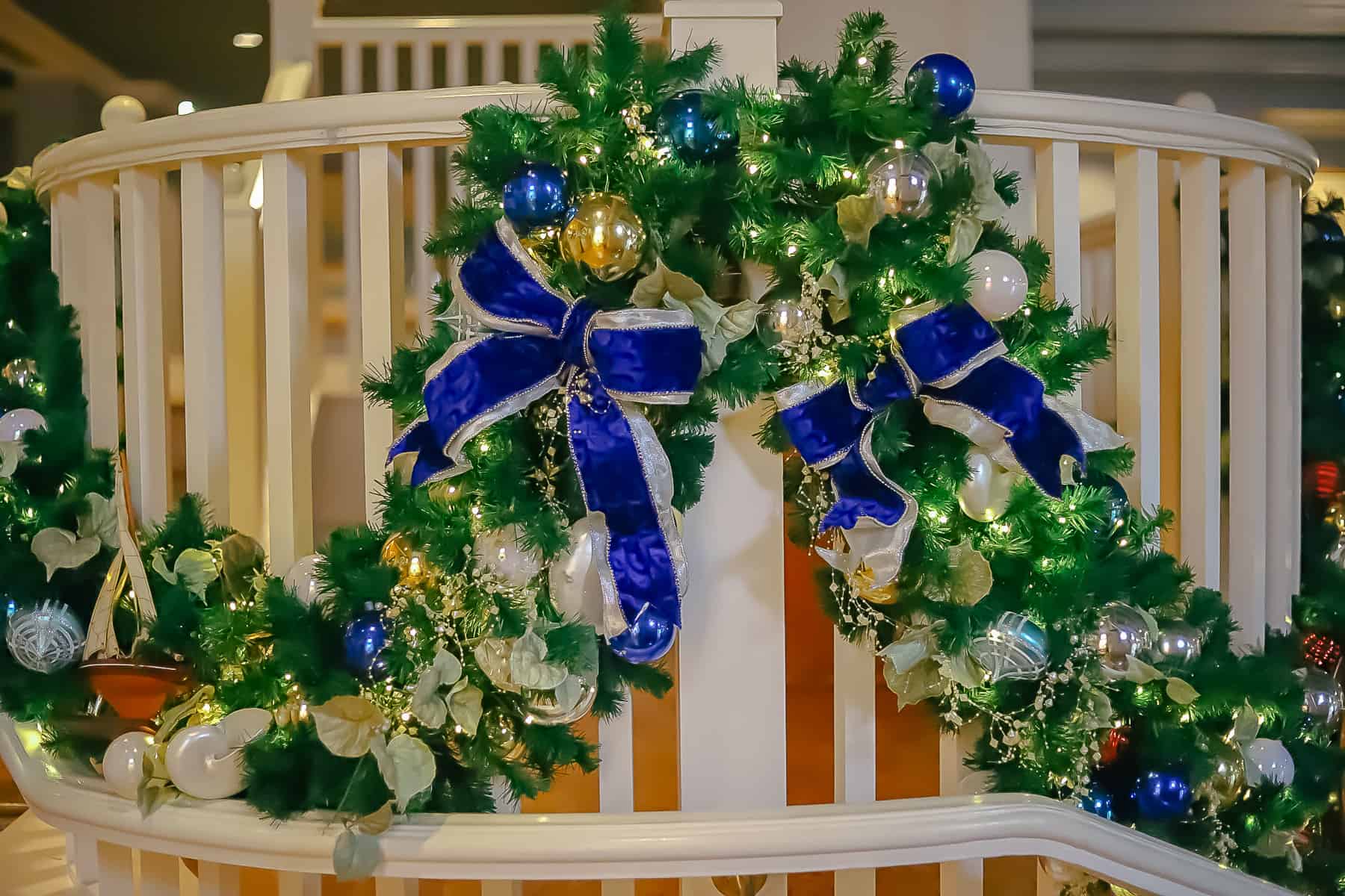 Two blue bows intertwined in holiday garland. 