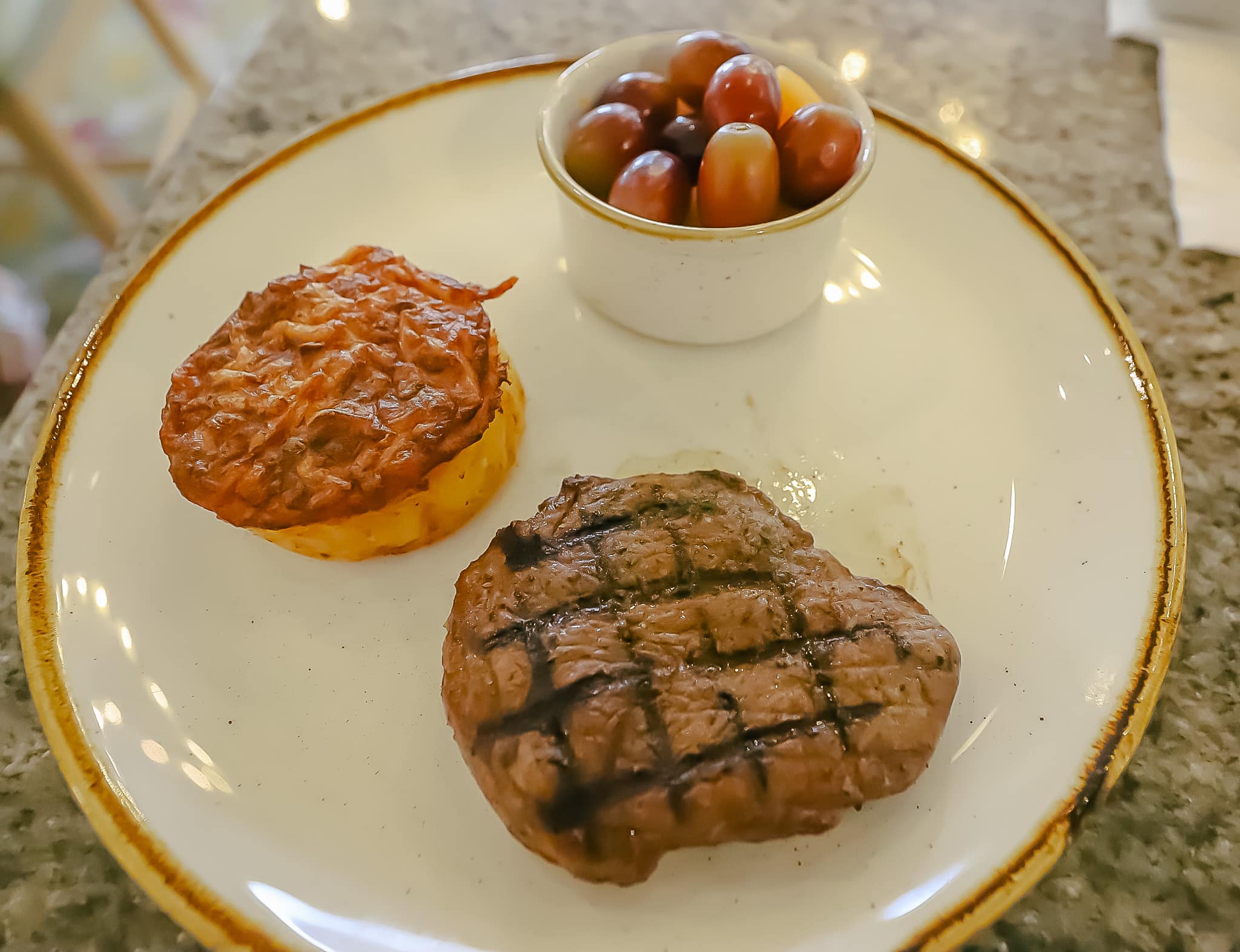 steak with cheesy potato casserole and grapes 