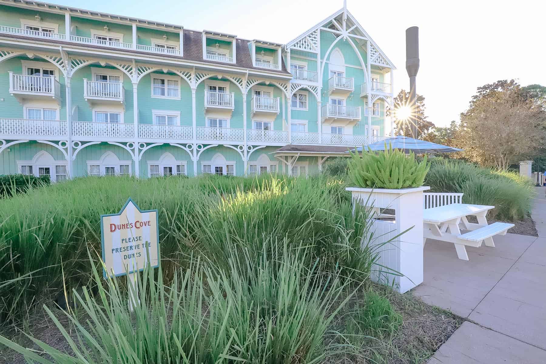 Disney's Beach Club Villas with a tiny star shaped sun and mint green backdrop. 