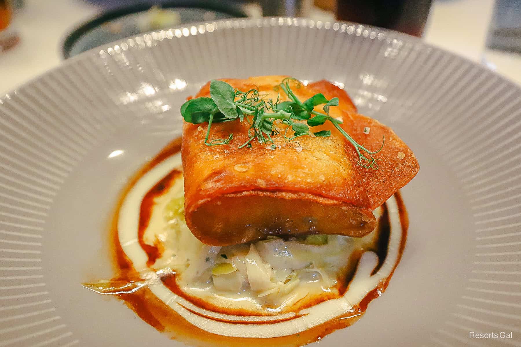 an order of the potato crusted snapper from Flying Fish sitting on a bed of leeks