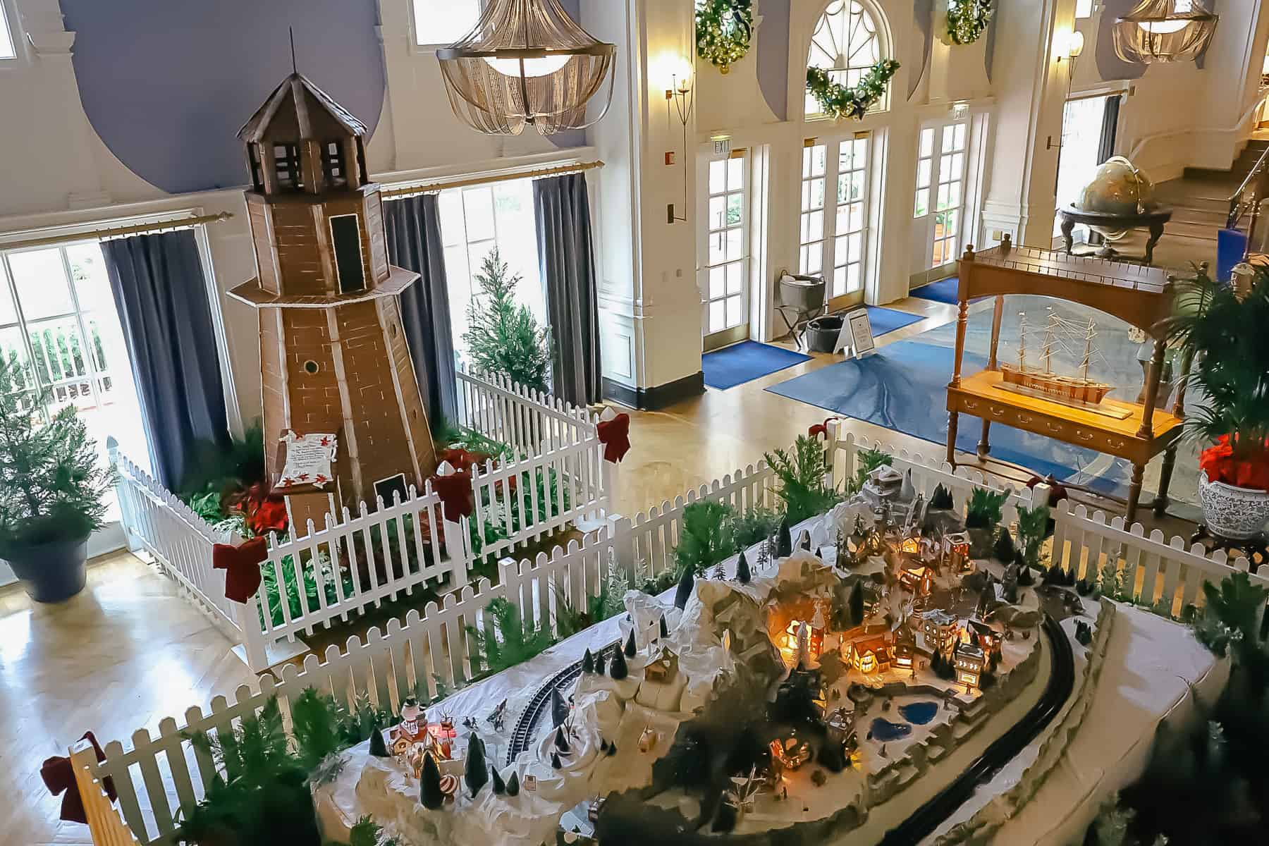 A view of the Yacht Club's lobby from the second floor showing the gingerbread display and train set.